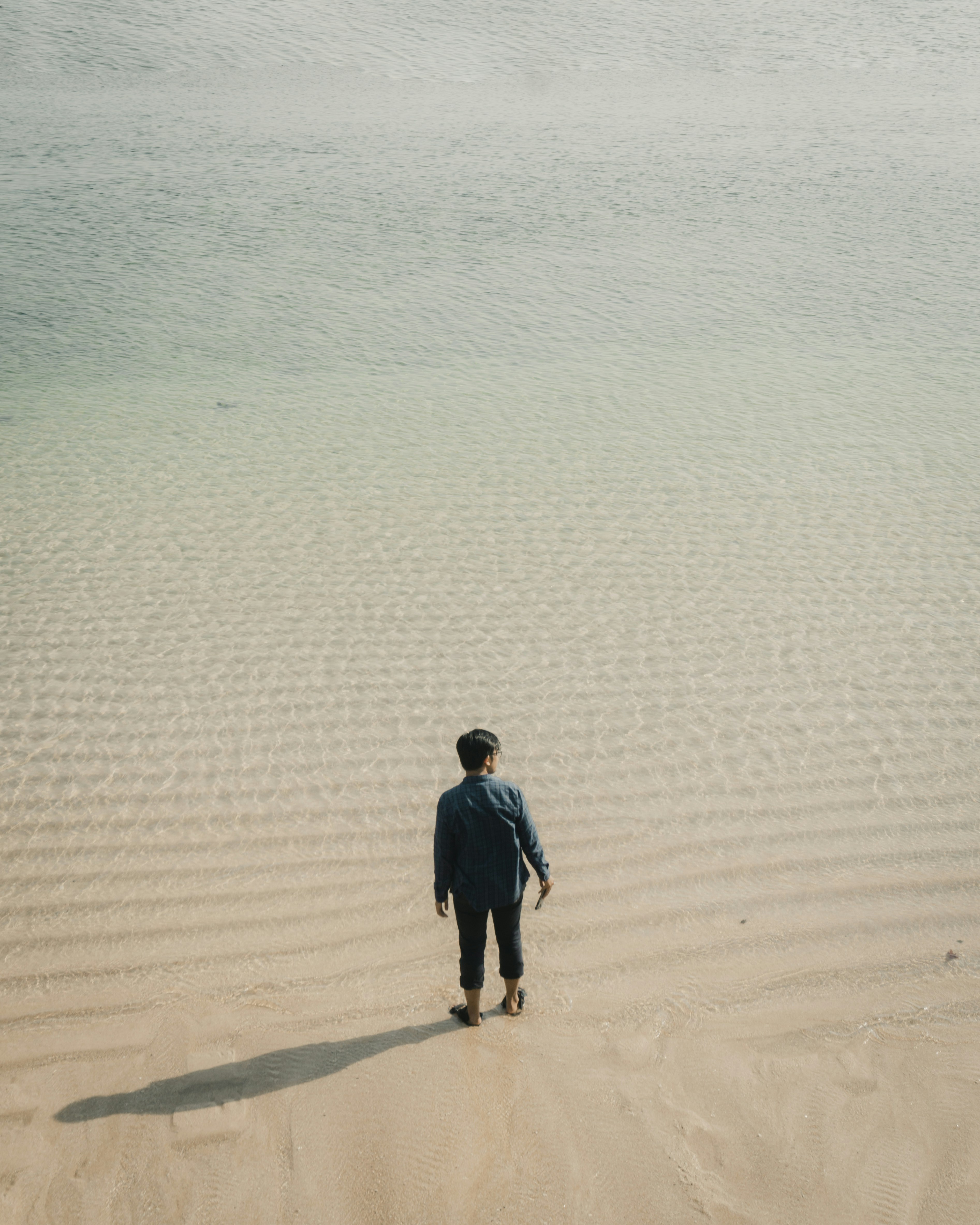 Man Standing in Clear Shallow Sea
