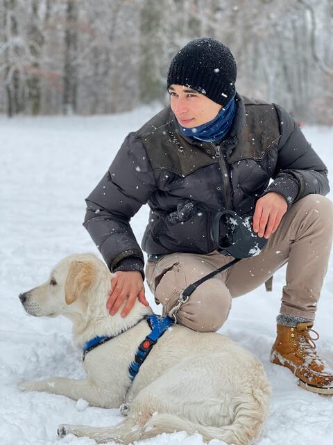 Man With Dog In Snowy Forest