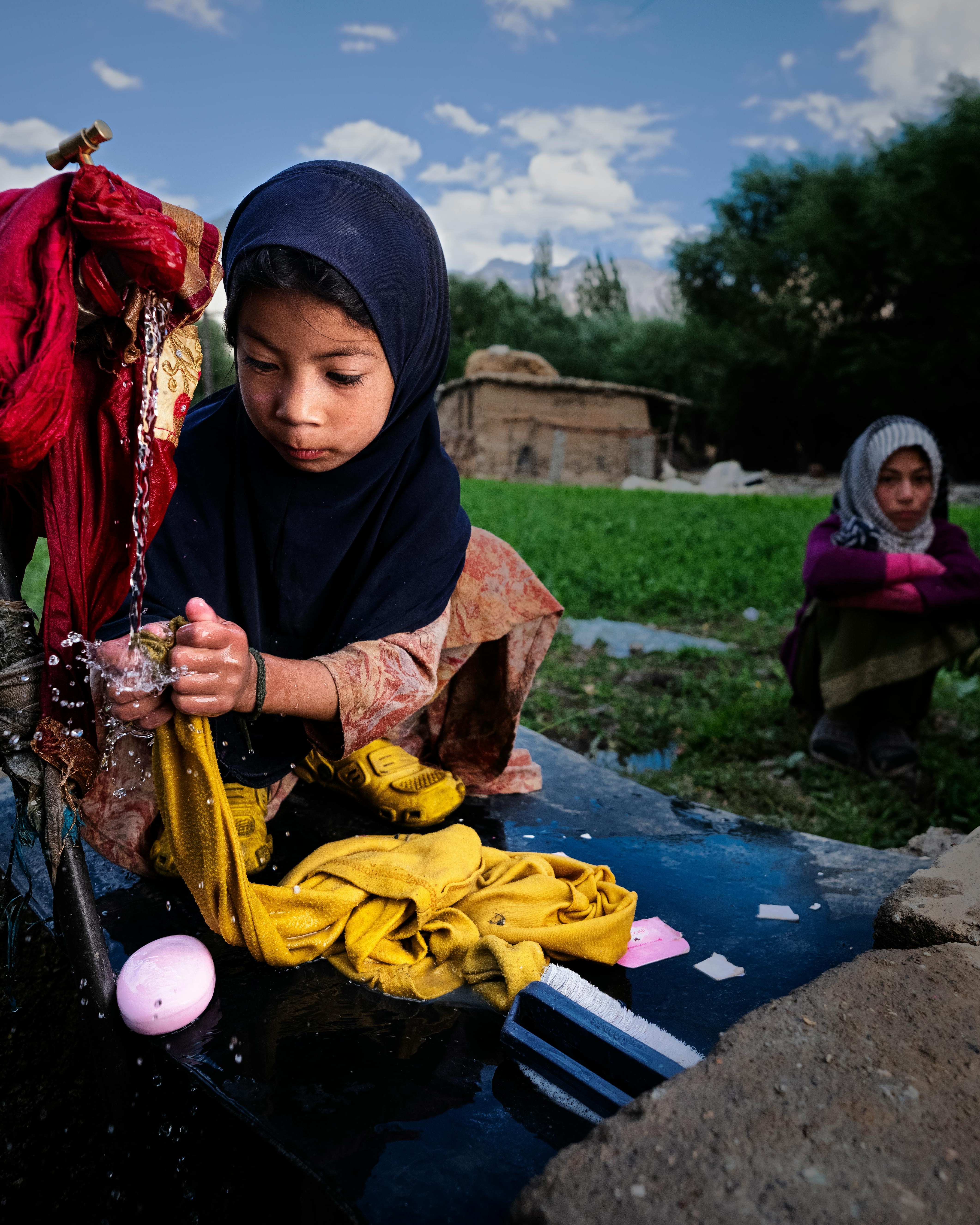 Girl Washing Clothes Outdoors