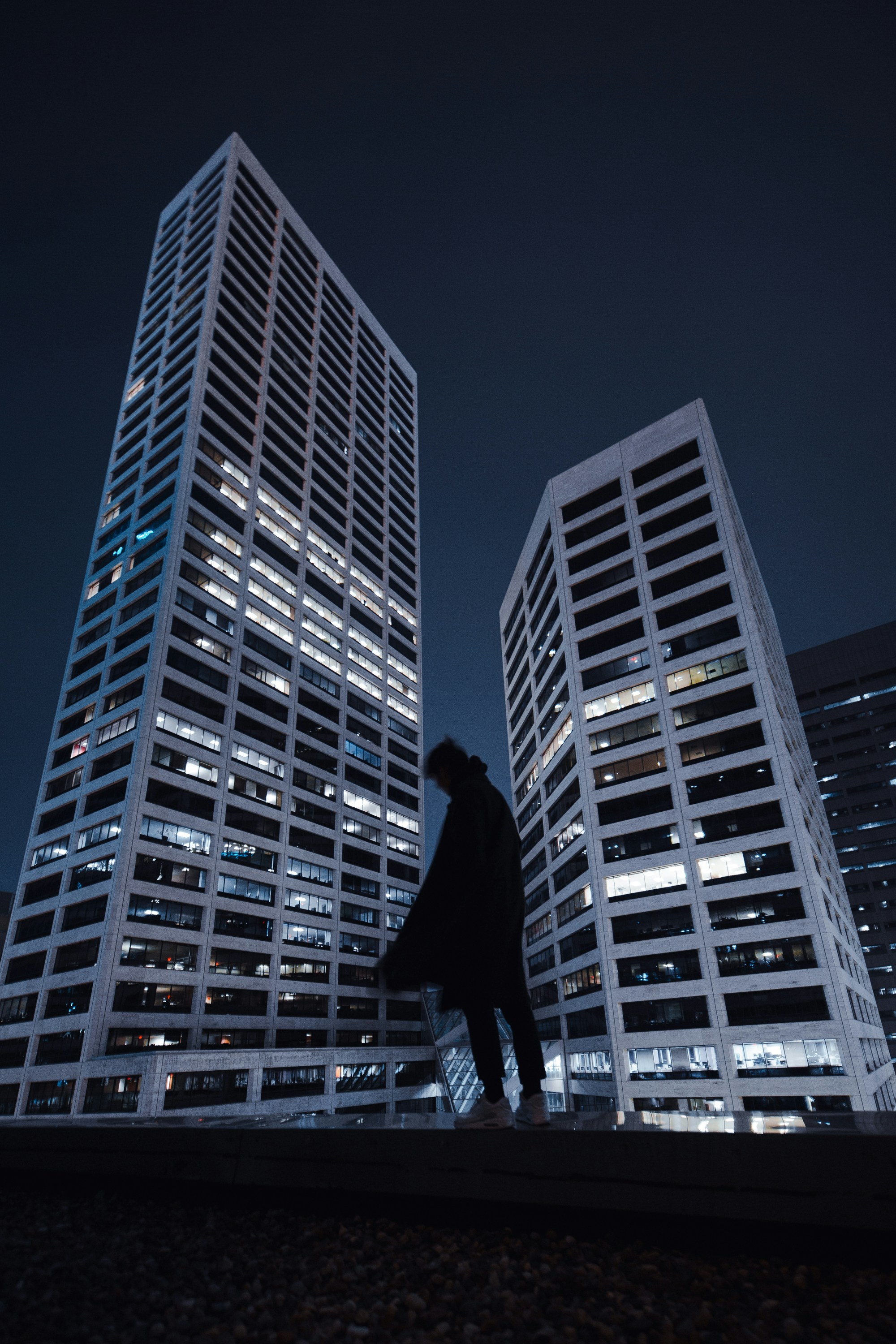 Silhouetted Person Before Night Skyscrapers