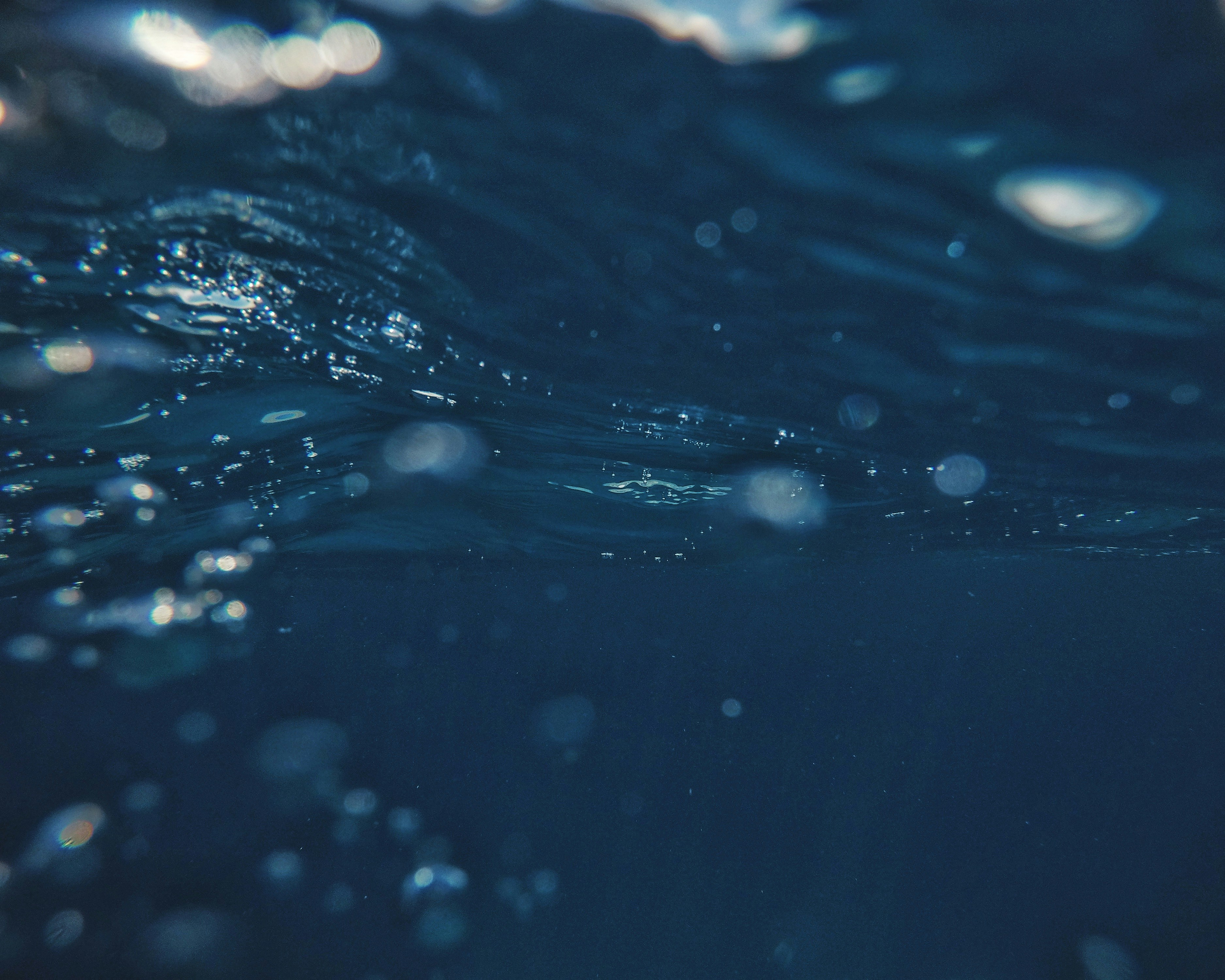Deep Blue Water Surface With Bubbles