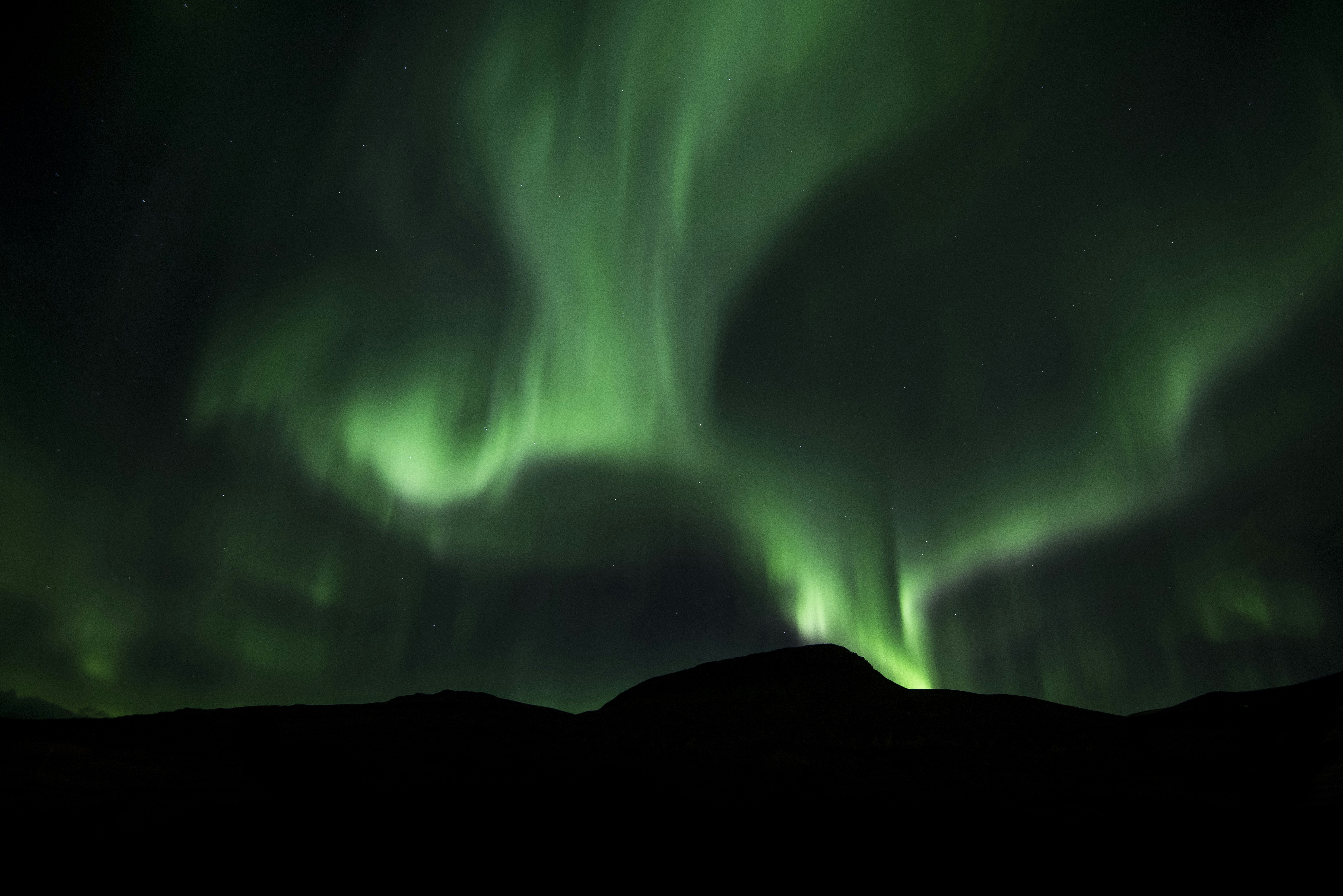 Green Aurora Over Night Mountains