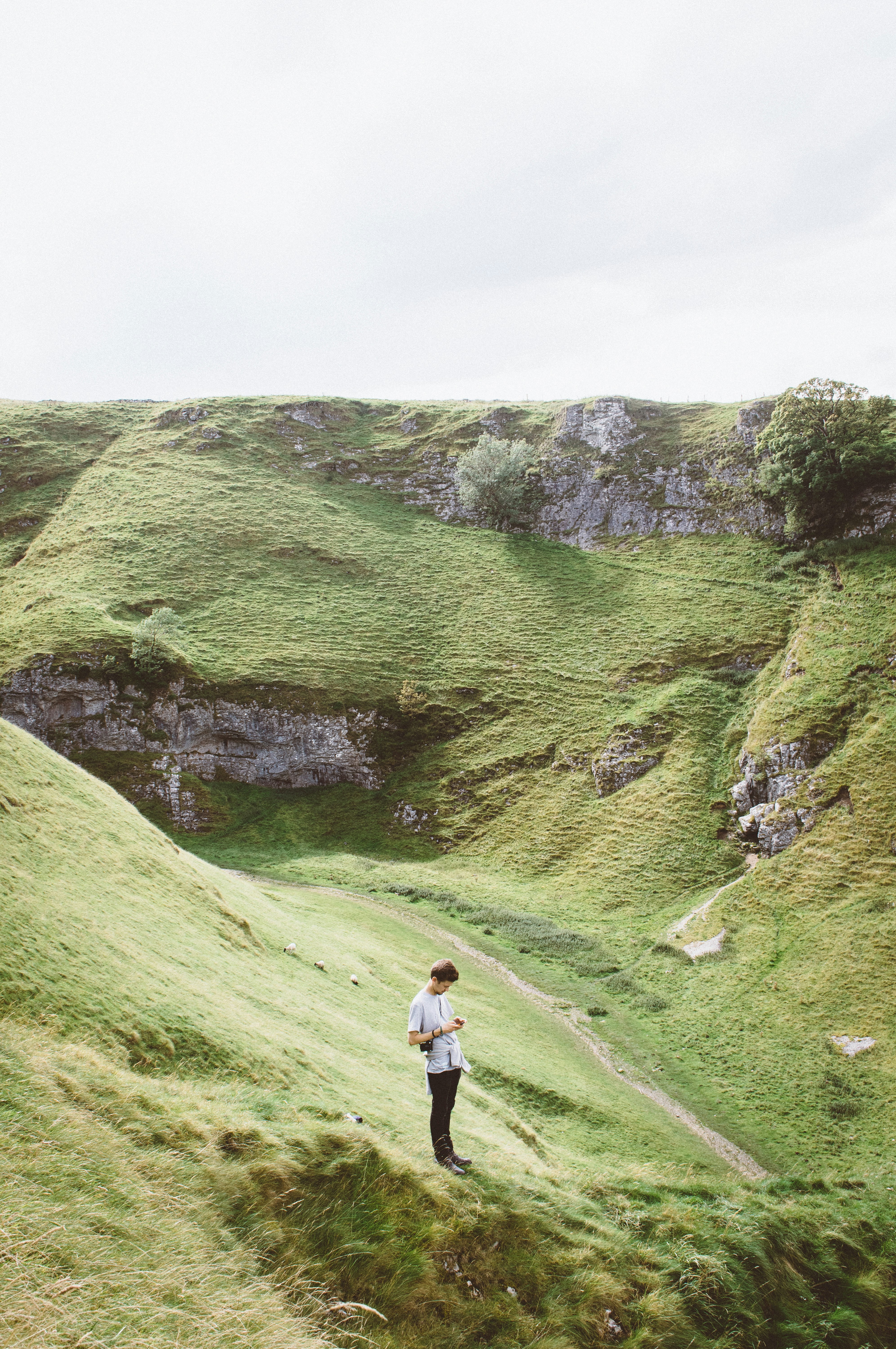 Man Standing in Grassy Valley