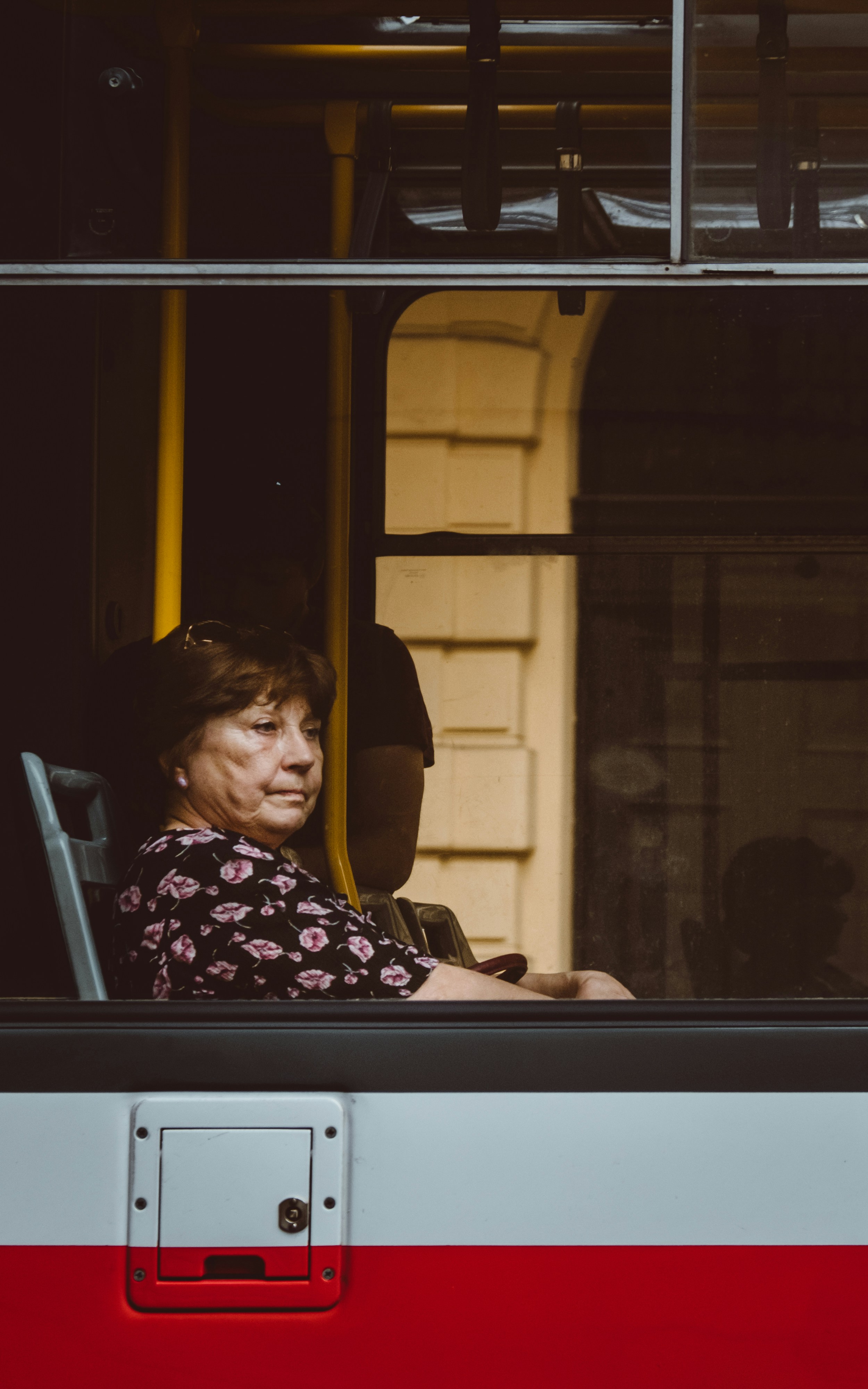 Older Woman Gazing Out Bus Window