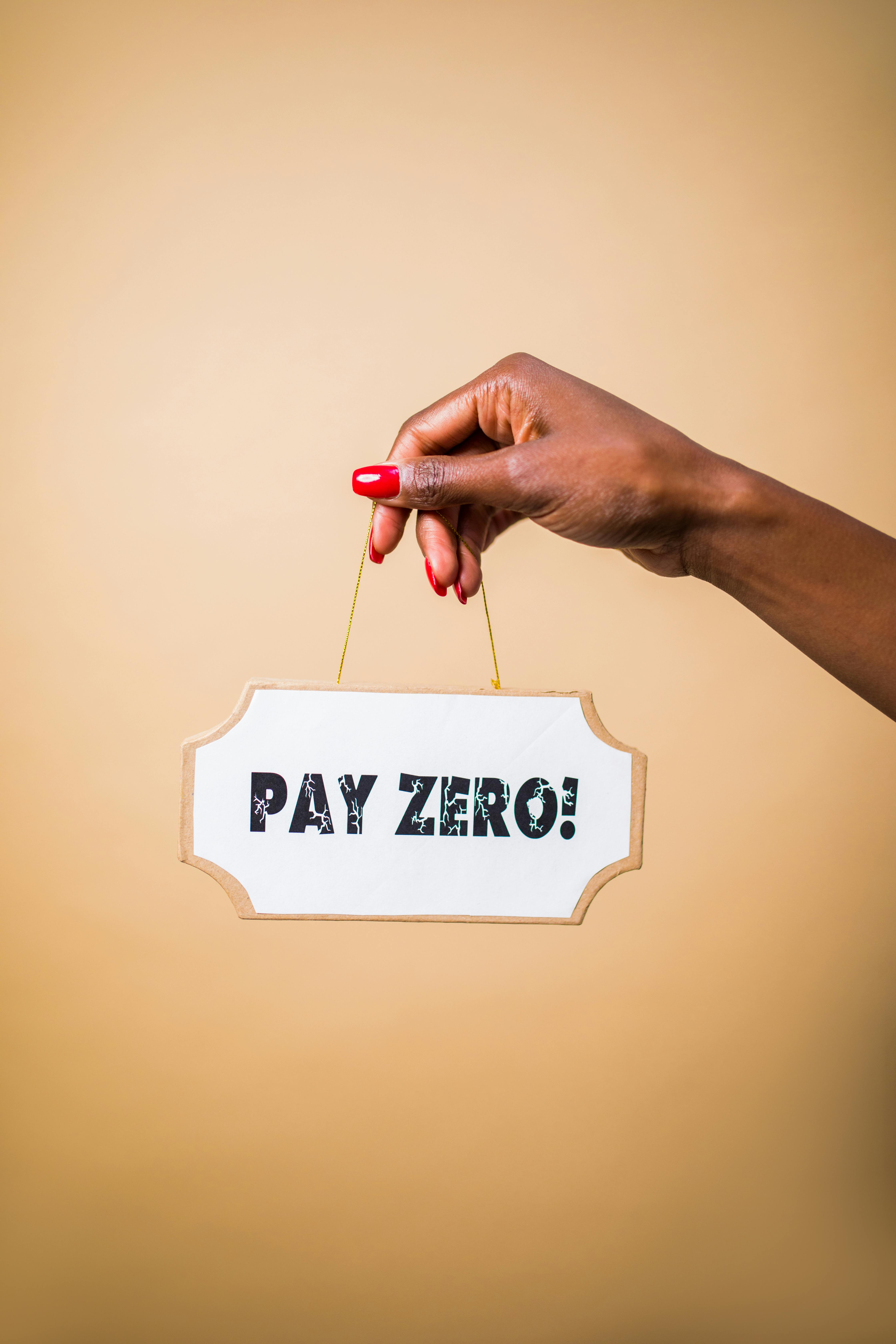 Hand Holding Pay Zero Sign