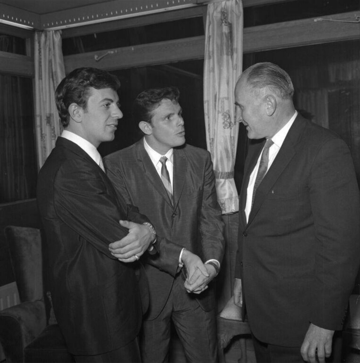 Three Men in Suits Conversing