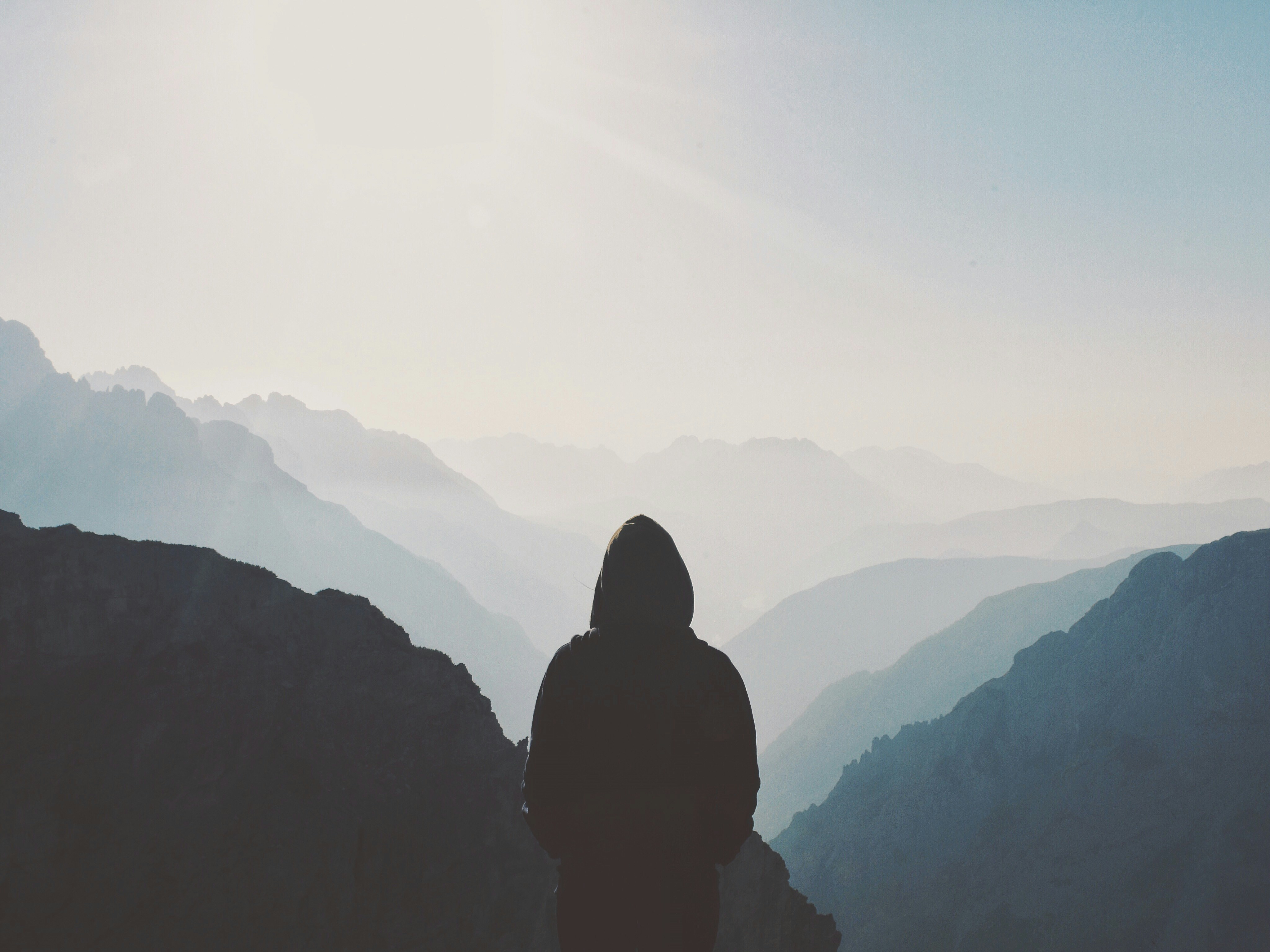 Hiker Overlooking Layered Mountains