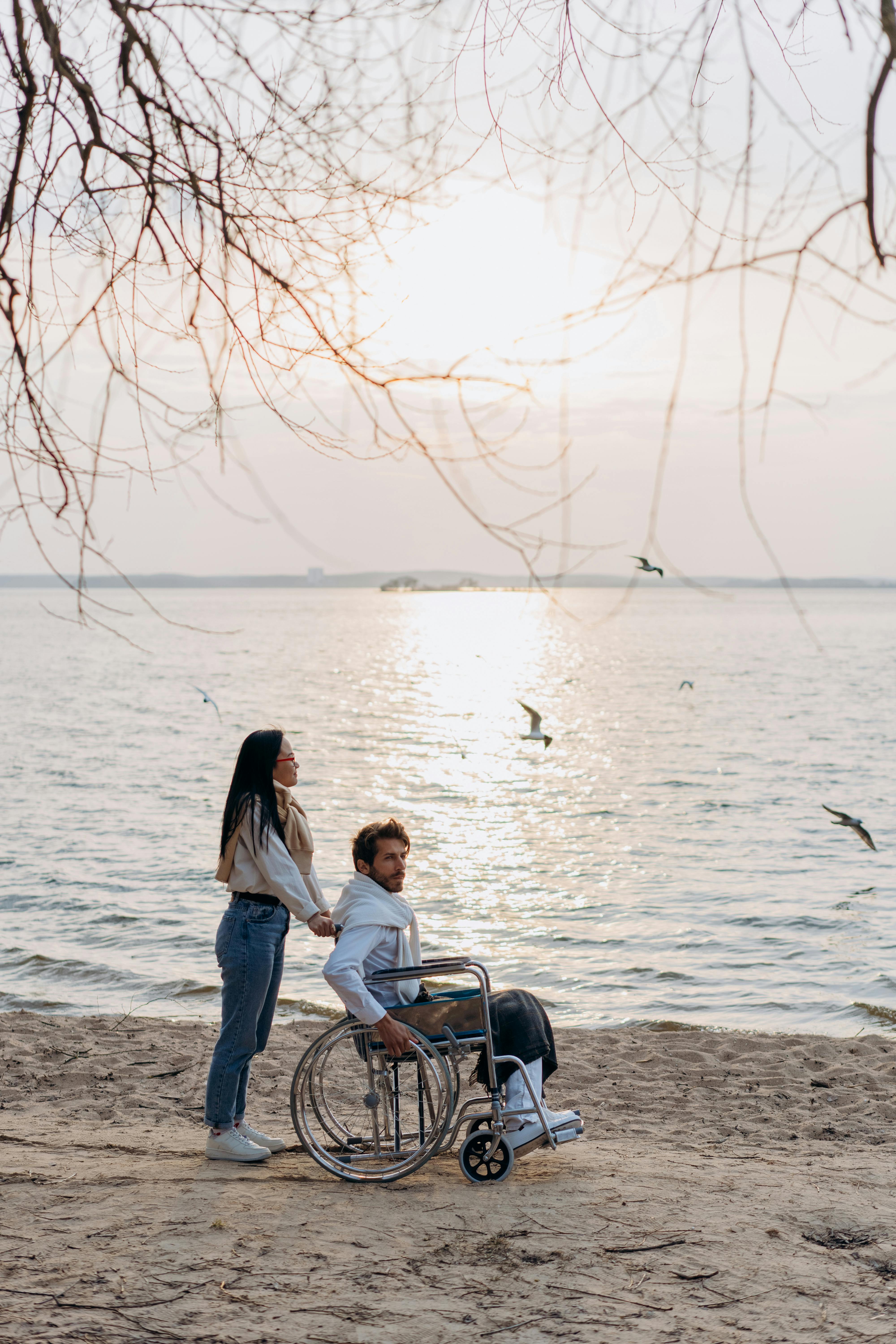 Couple Enjoying Sunset At Lakeside Beach