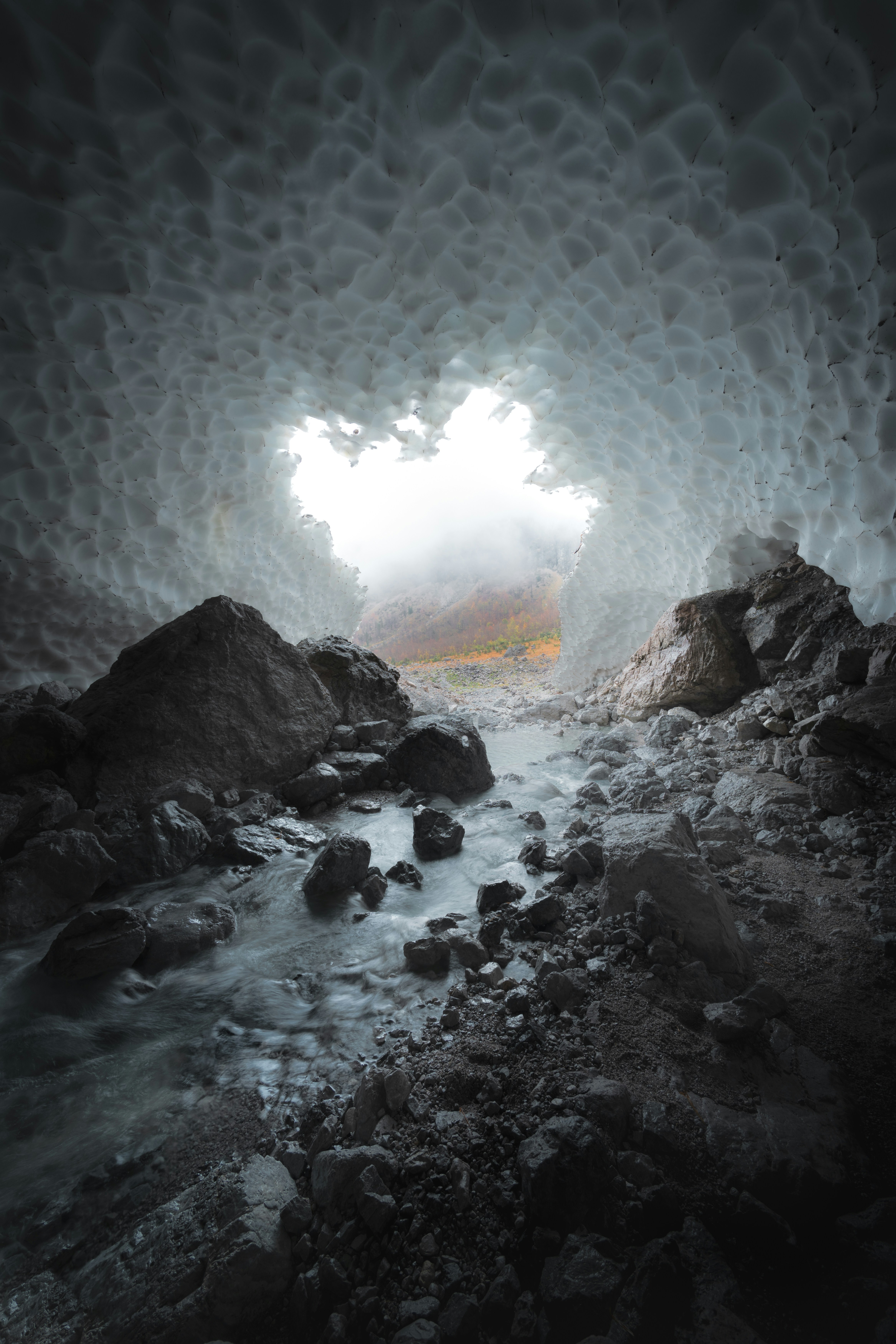 Stream Flowing Through Glacial Ice Cave