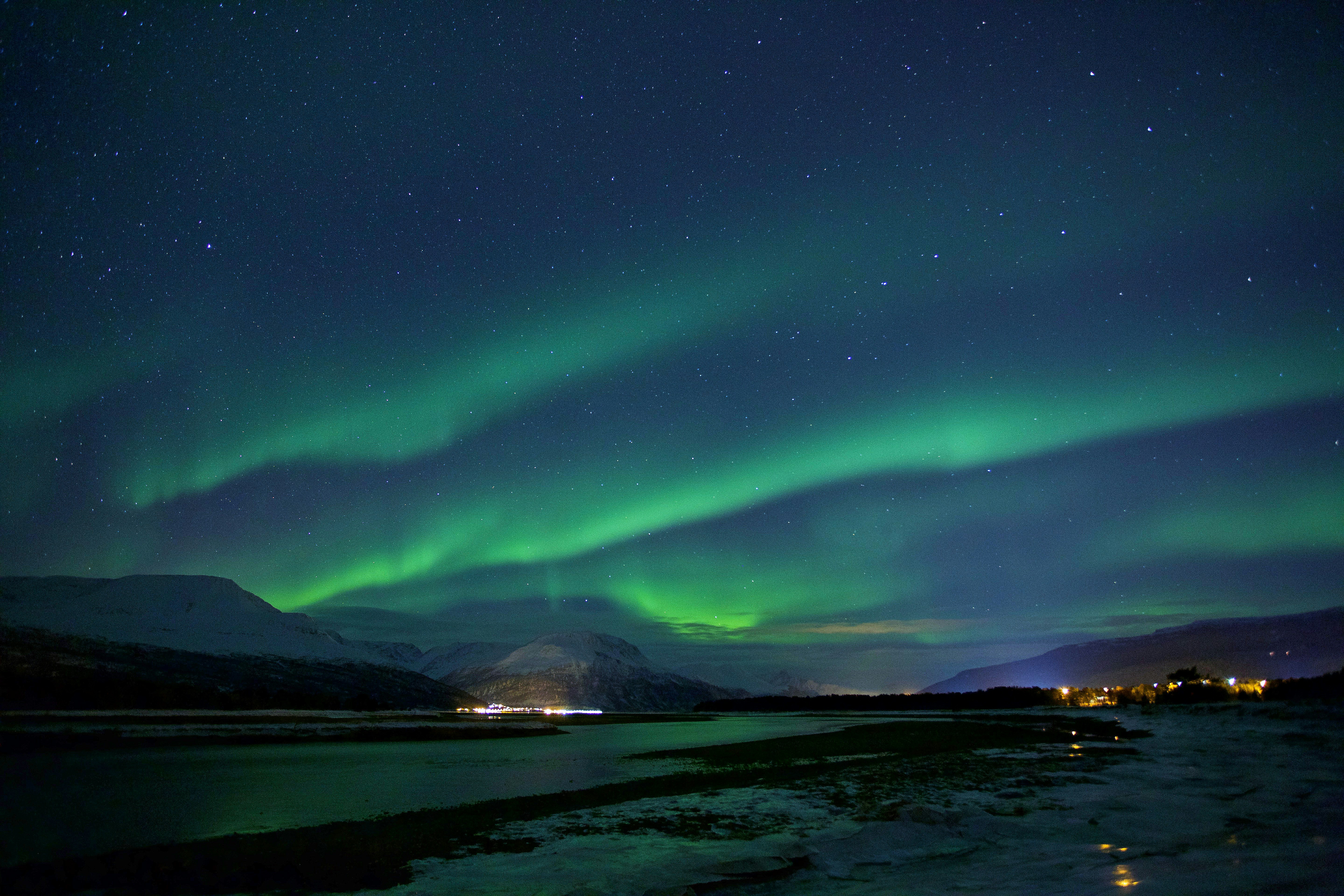 Northern Lights over Snowy Night Landscape
