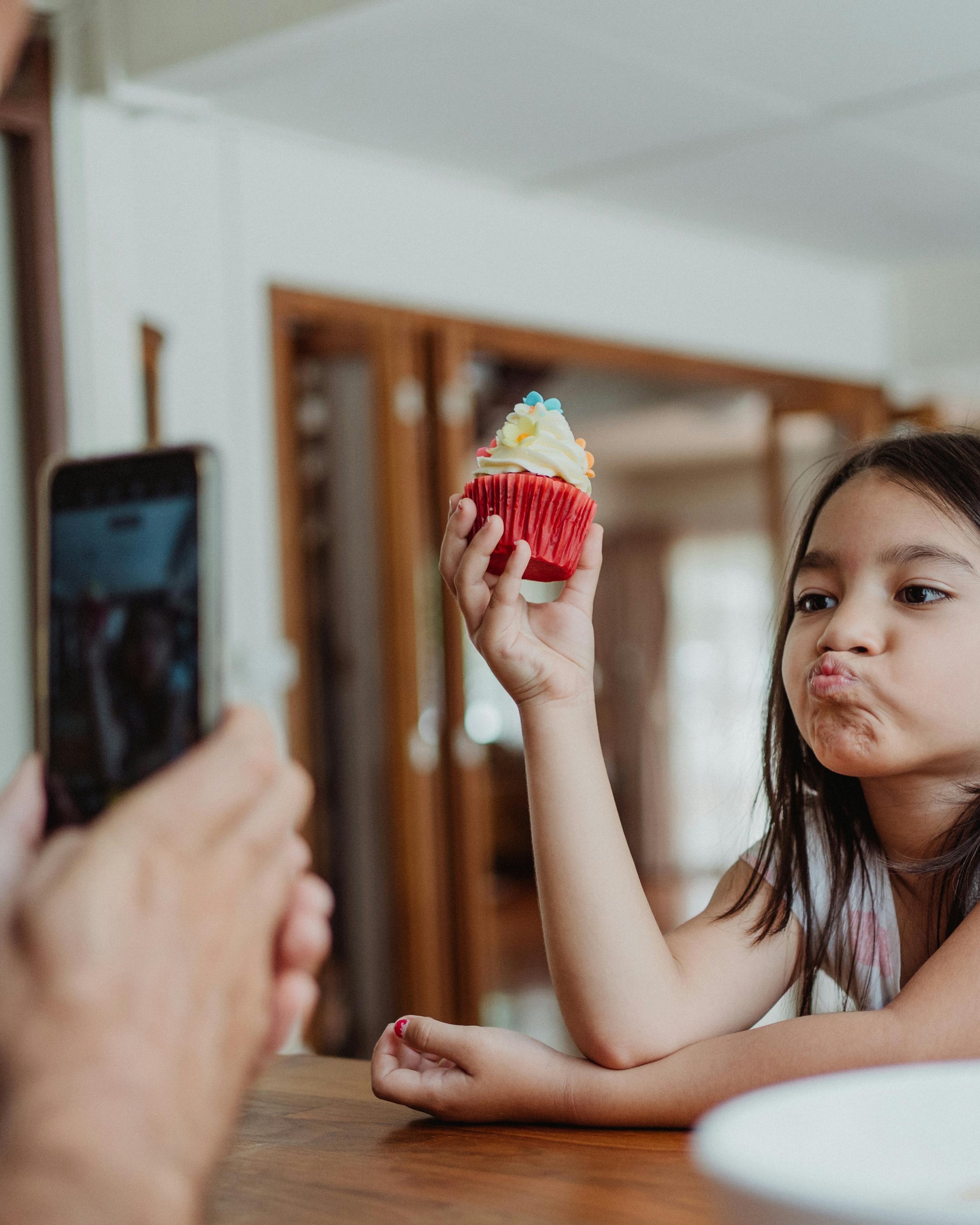Girl Posing With Cupcake For Photo