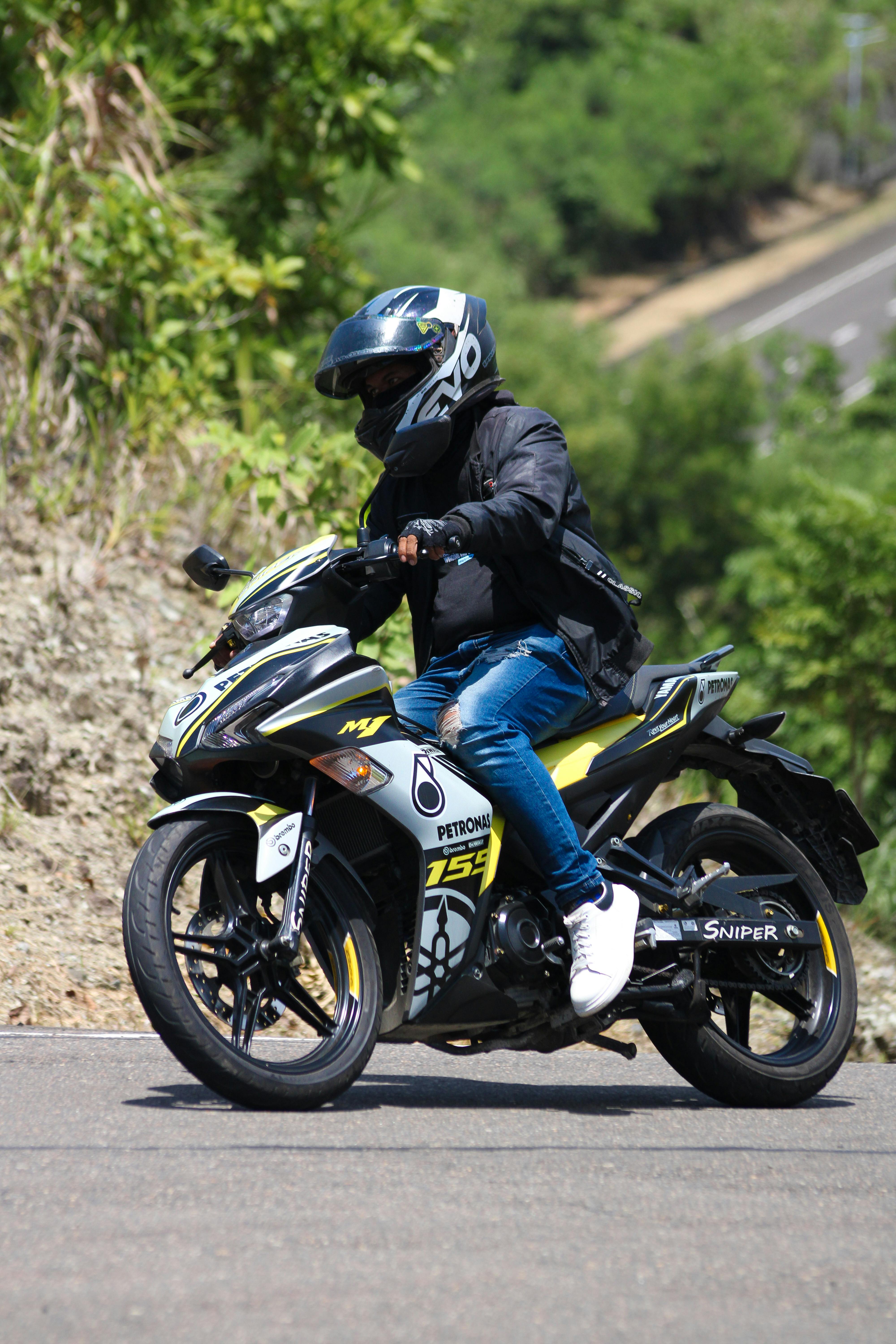 Motorcyclist Riding on Mountain Road