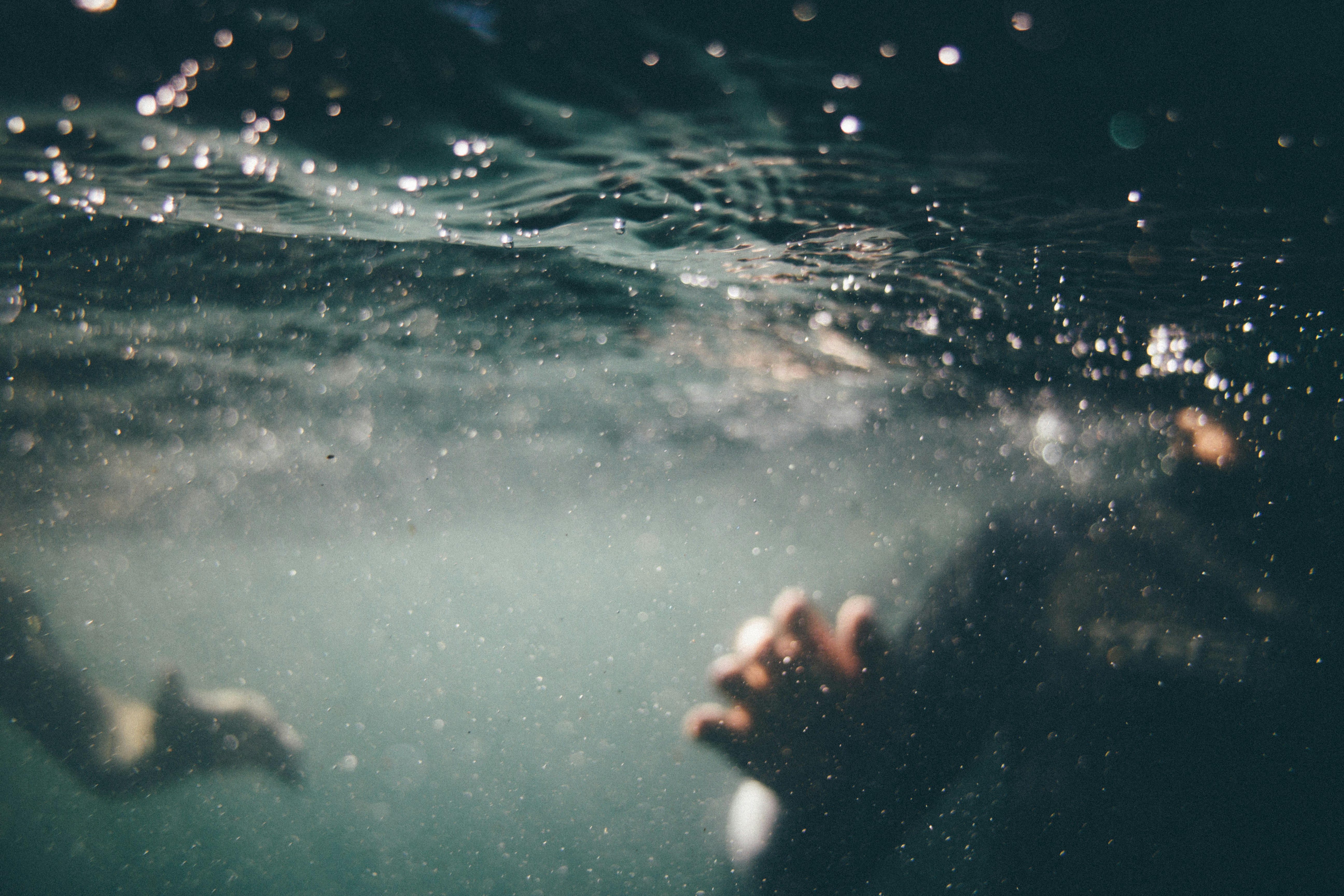 Underwater View of Submerged Person's Hands