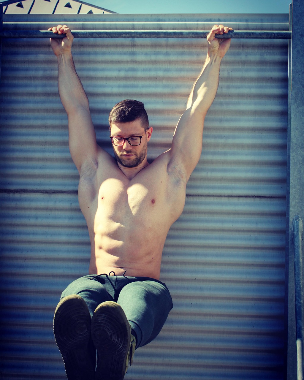 Muscular Man Doing Outdoor Hanging Exercise