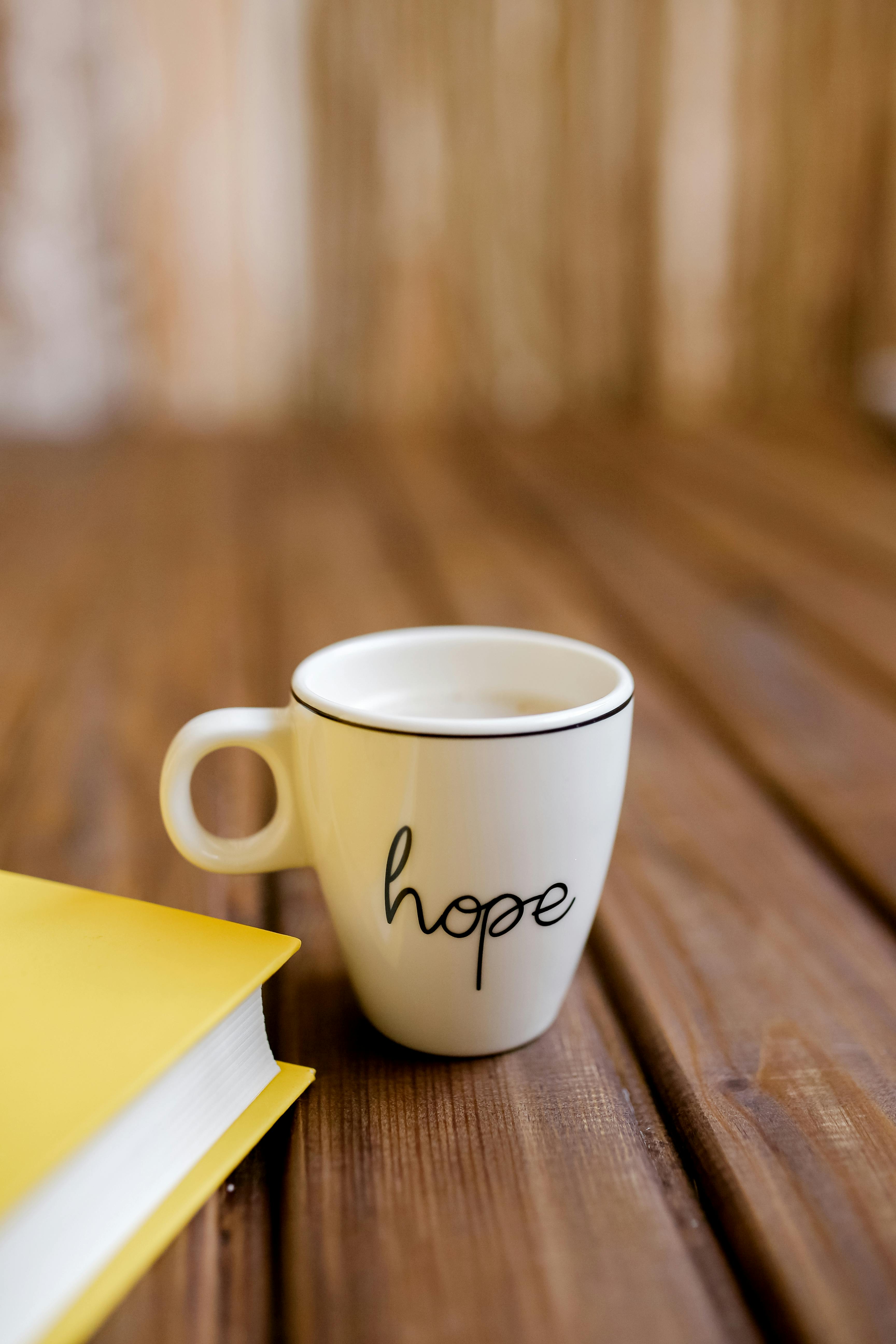 Hope Mug And Book On Wooden Table