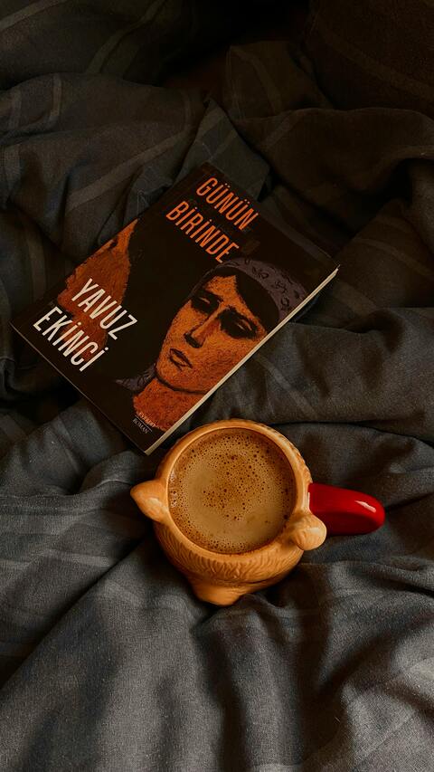 Book and Frothy Coffee on Bedding