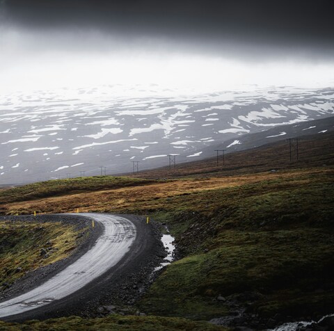 Winding Road Through Snowy Highland