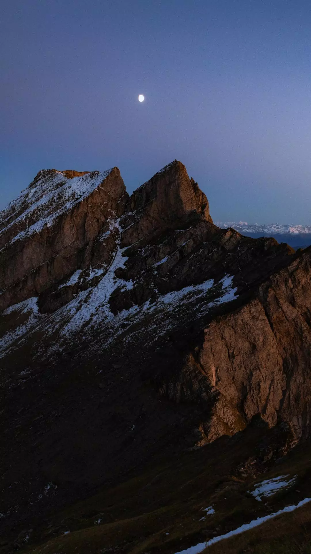 Moon Over Snowy Rocky Peaks