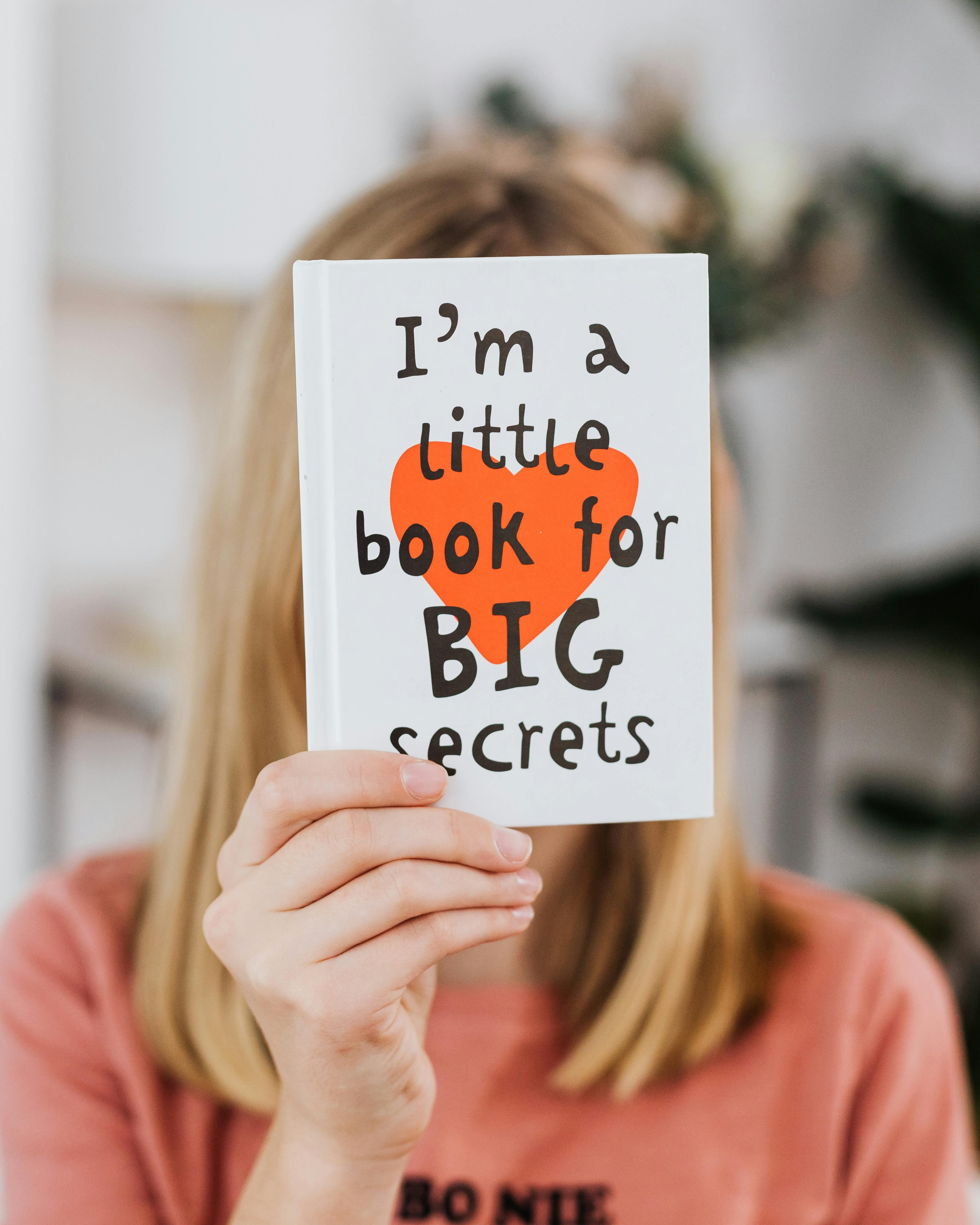 Woman Holding a Little Book for Big Secrets