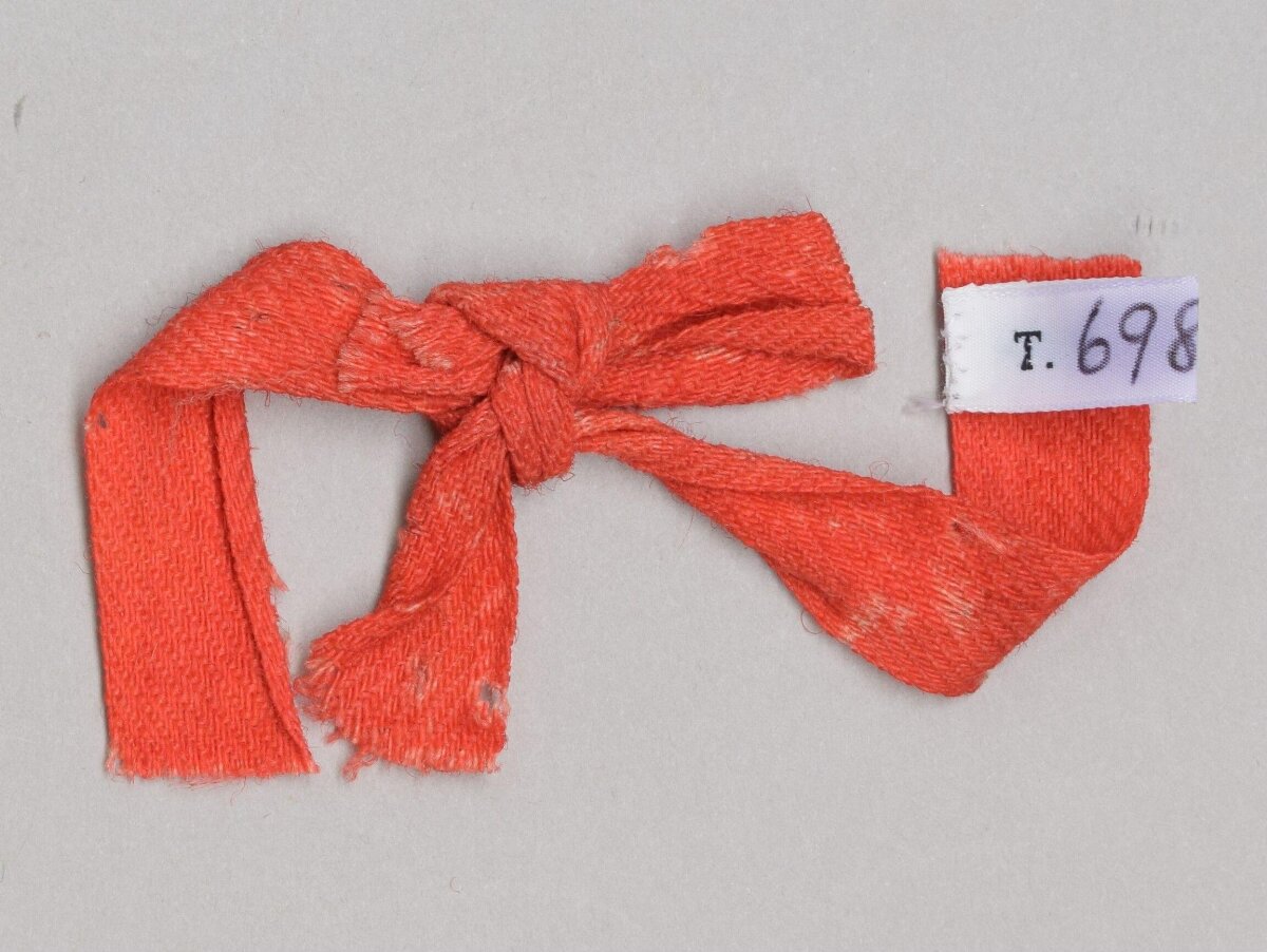 Tied Orange Textile Sample with Label