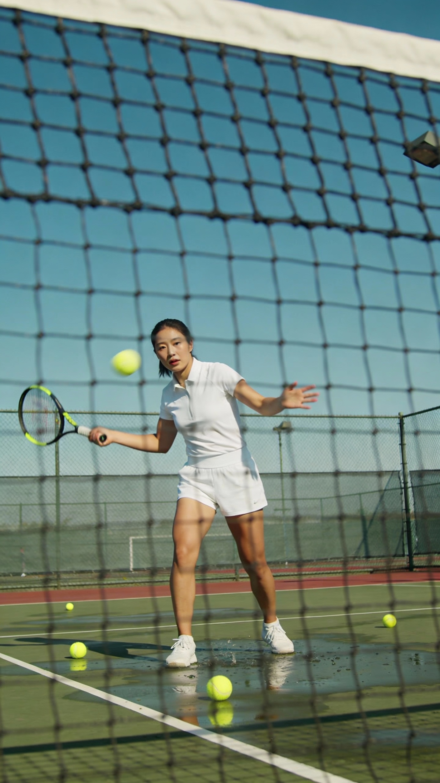 Woman Practicing Tennis on Outdoor Court