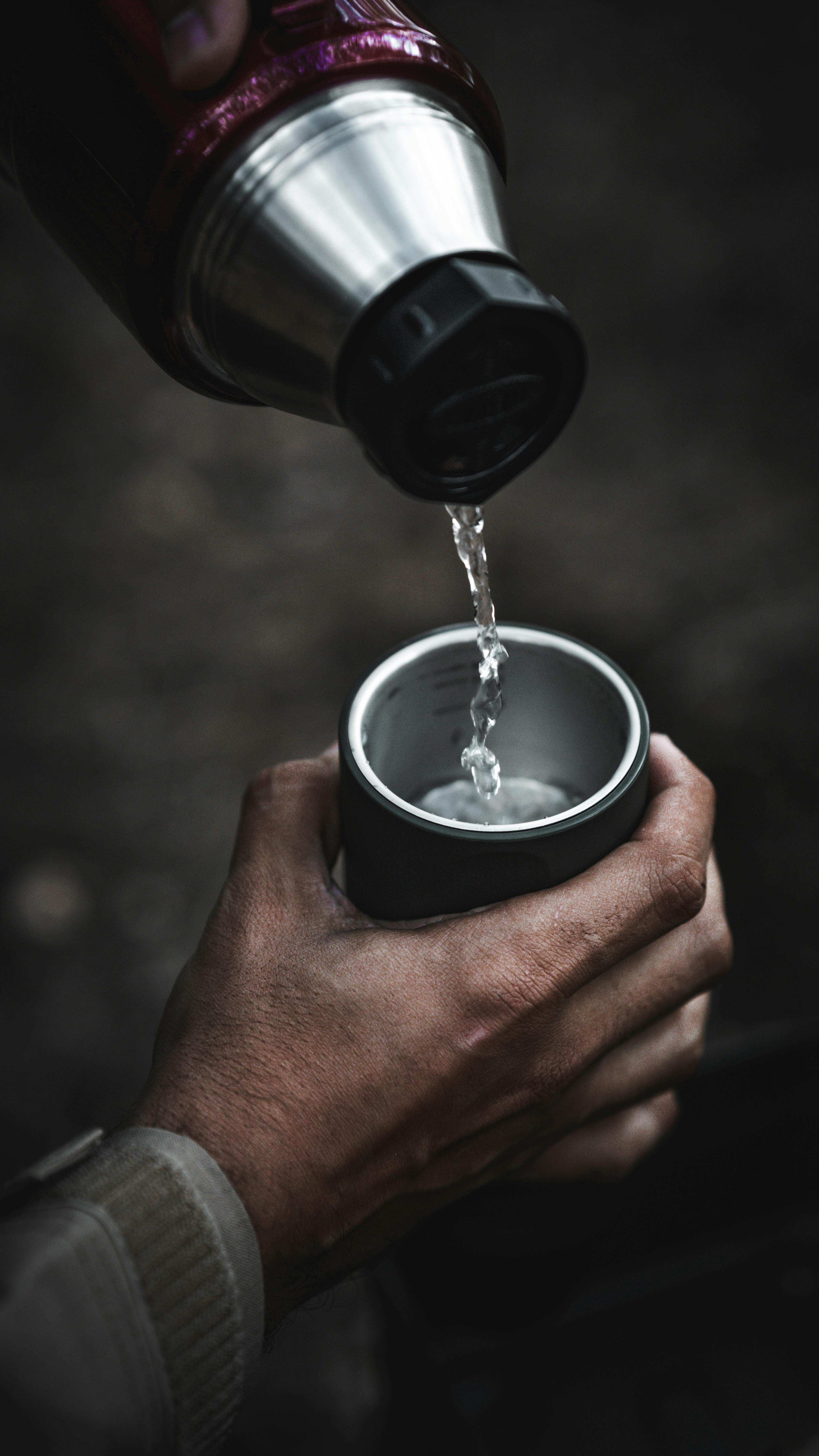 Pouring Hot Drink From Thermos Into Mug