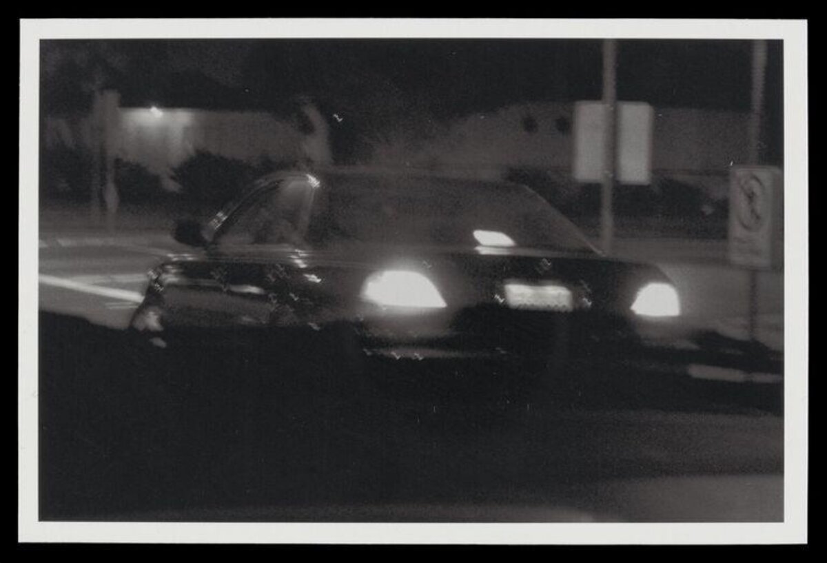 Car with Headlights at Night