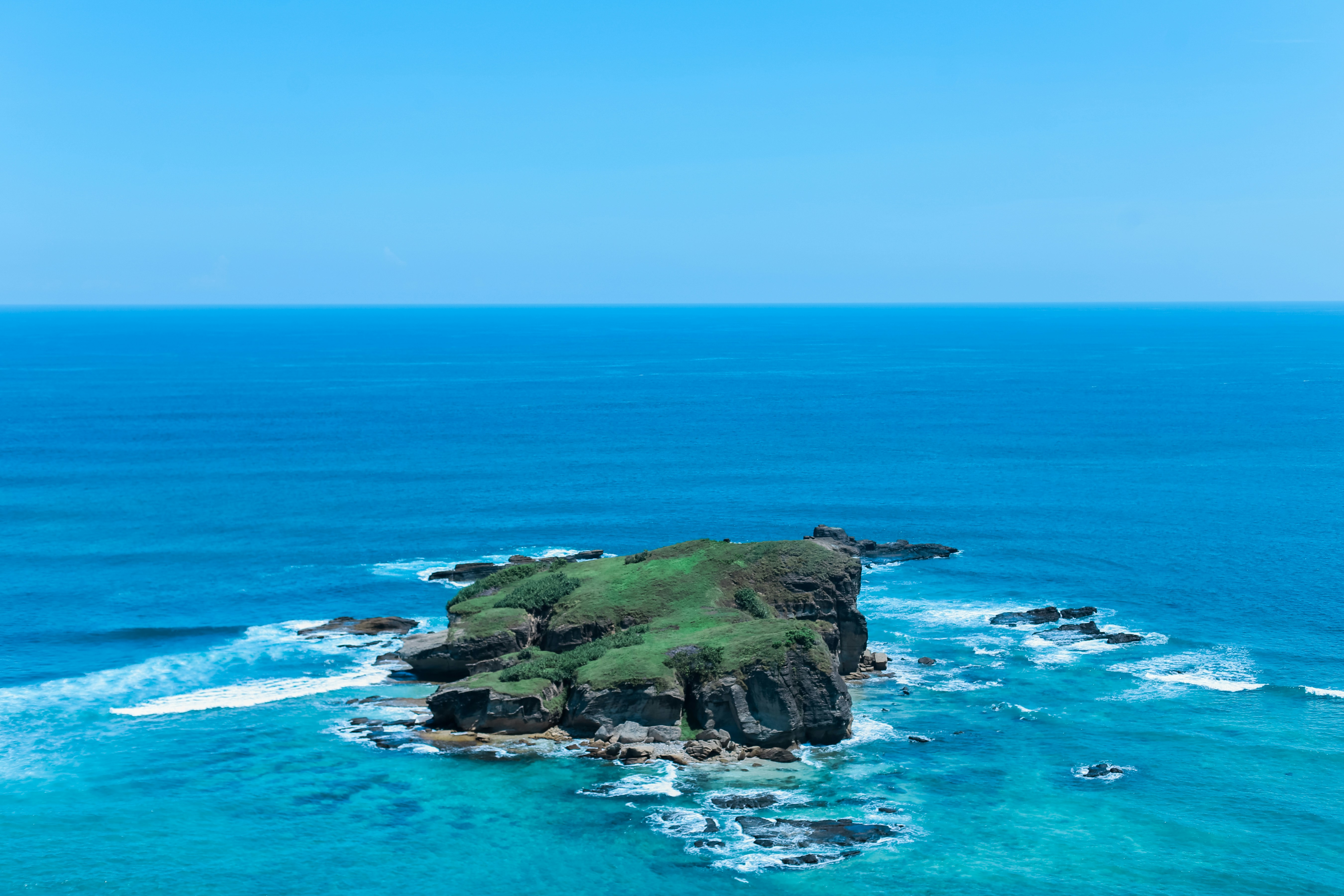 Grassy Islet in Blue Ocean