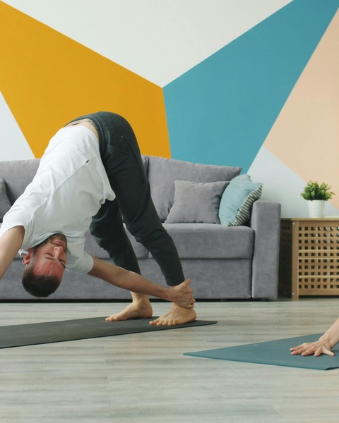 Man Practicing Yoga At Home