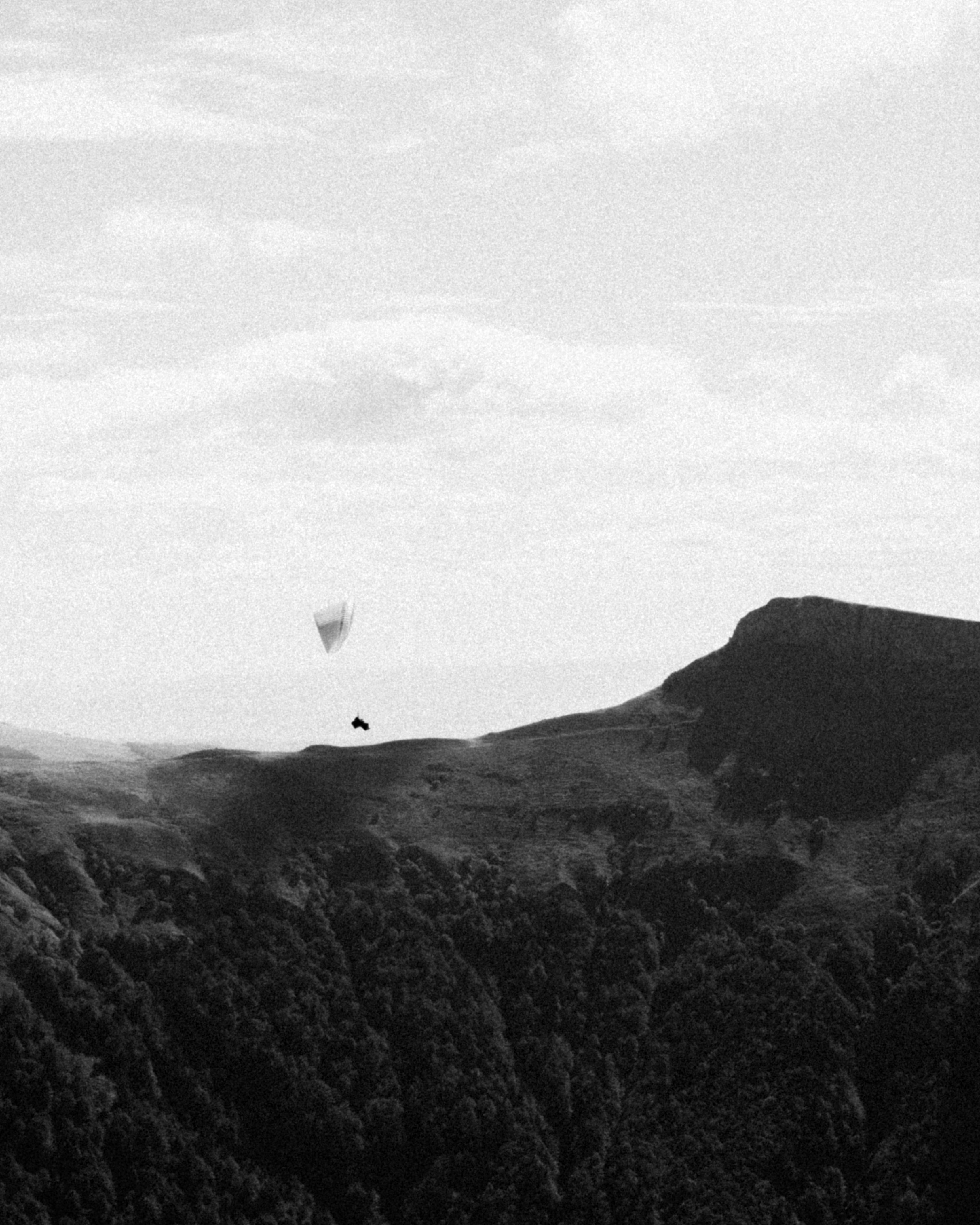 Paraglider Over Mountain Landscape
