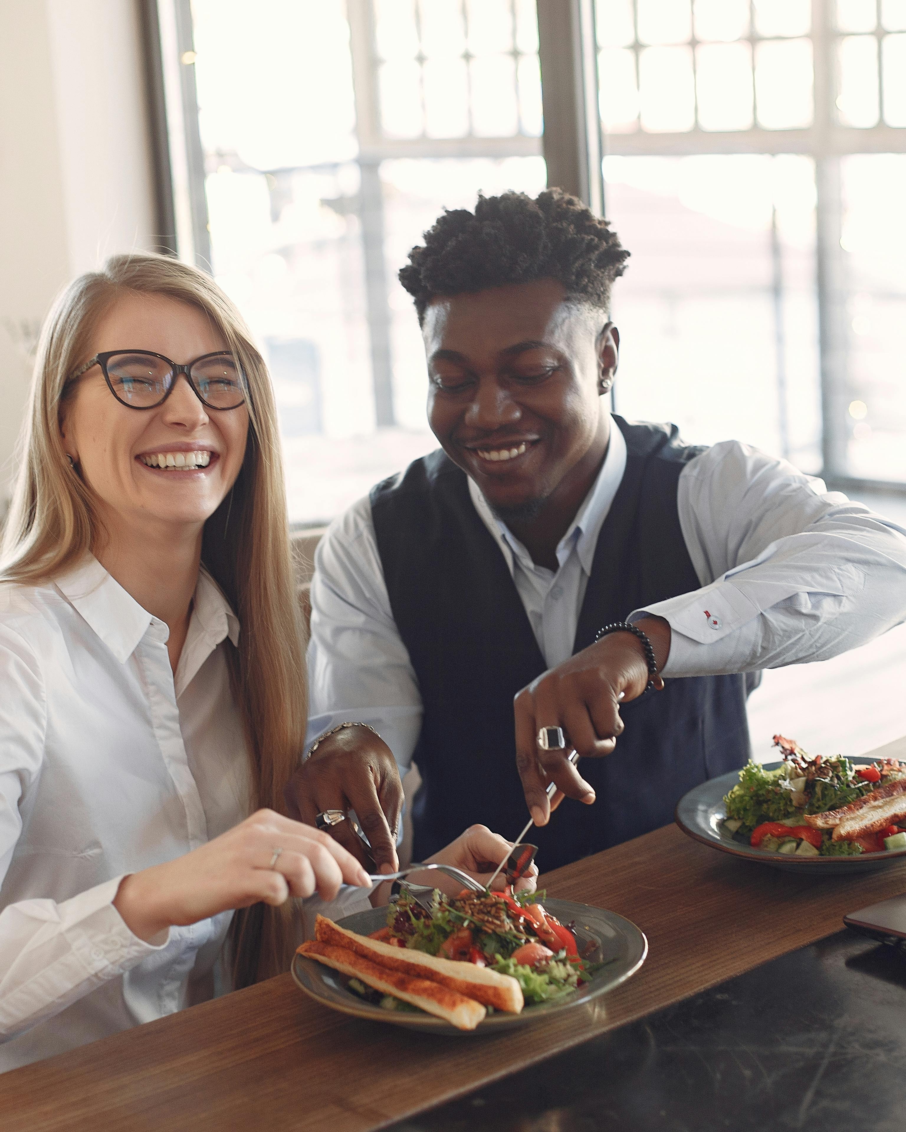 Two Friends Laughing Sharing a Meal