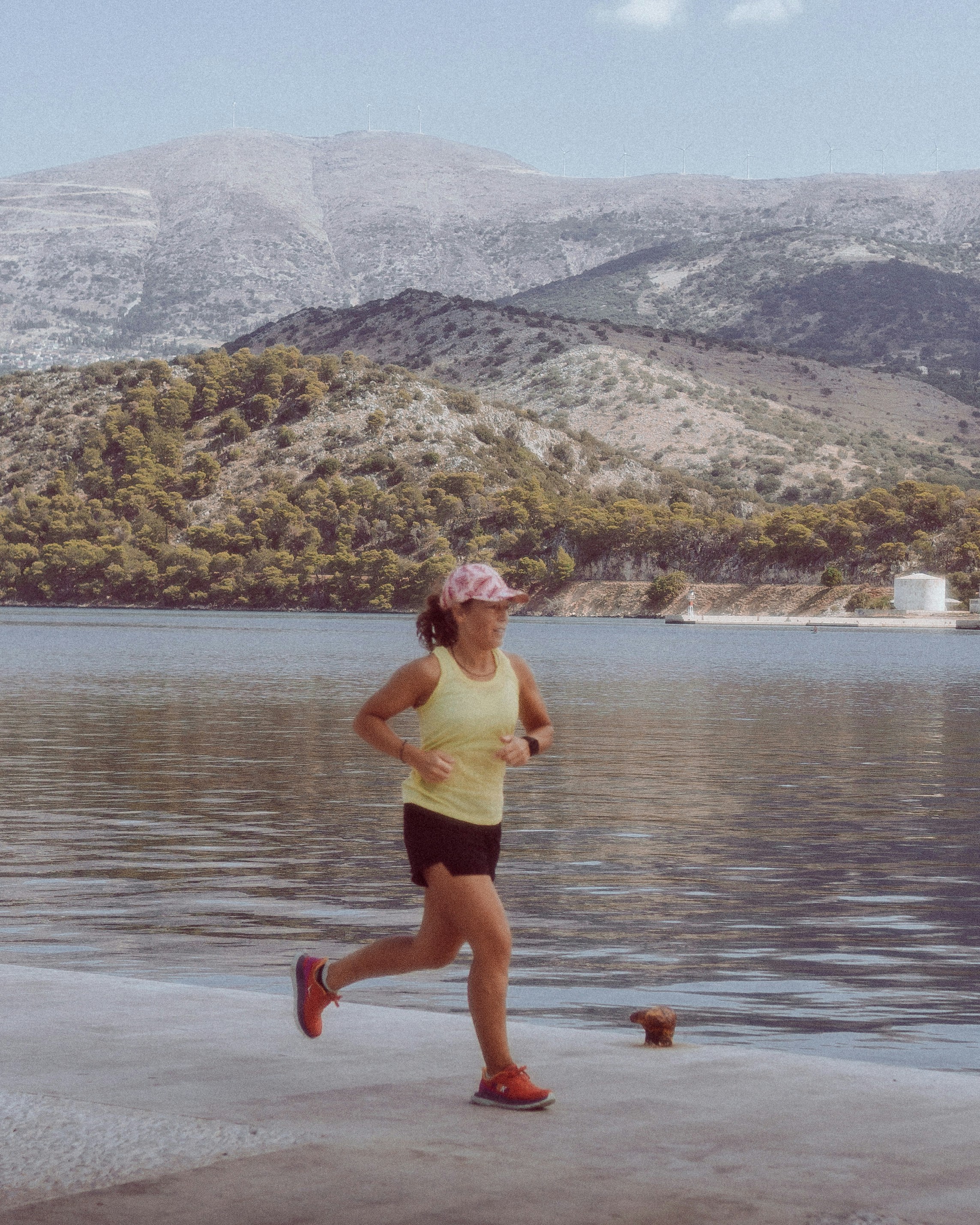 Woman Jogging By Coastal Water