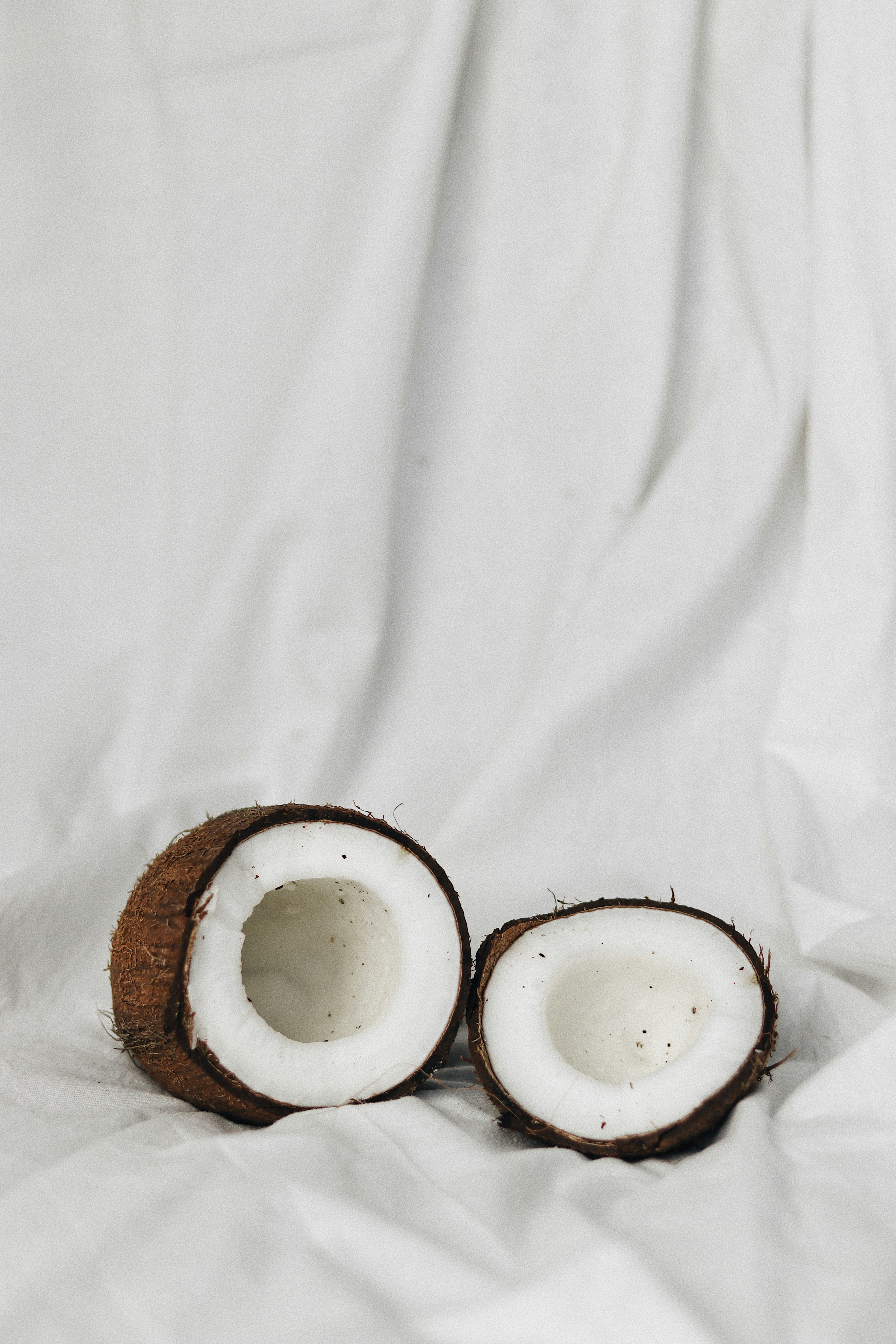 Two Halved Coconuts on White Cloth — Fruit Encyclopedia
