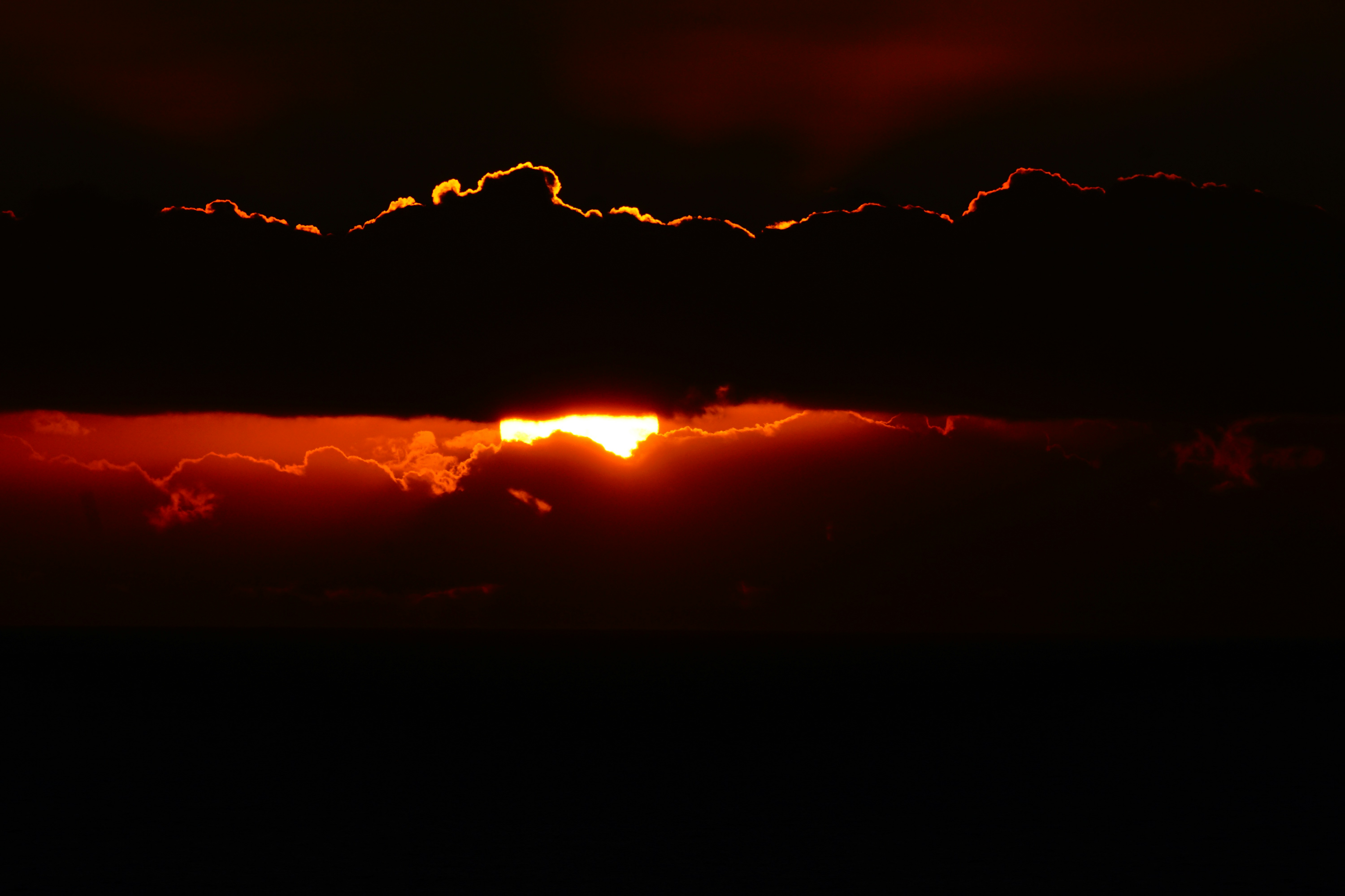 Sun Peeking Through Clouds at Sunset