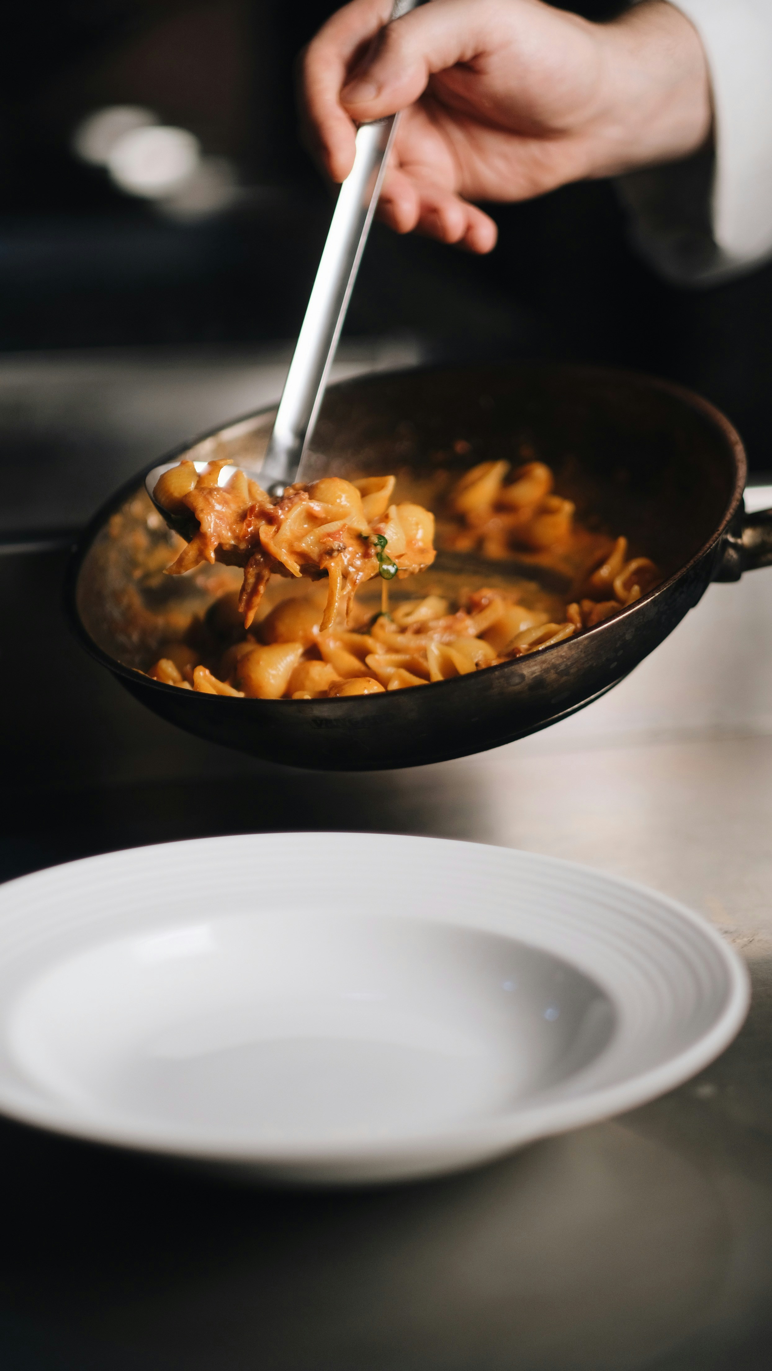 Chef Serving Creamy Shell Pasta