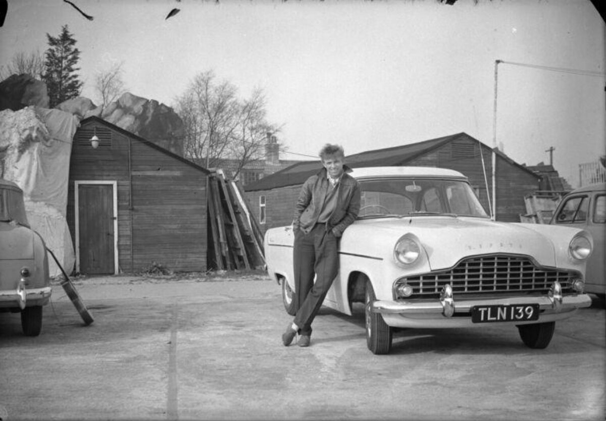 Man Leaning on Mid-century Classic Car