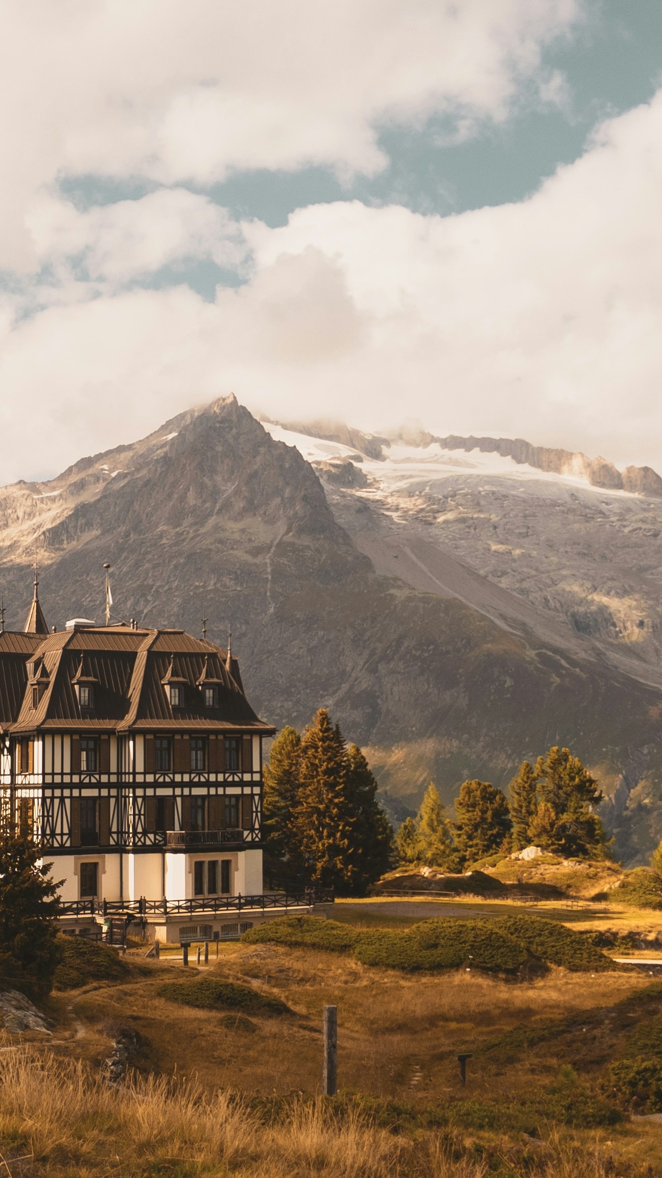Alpine Mansion Below Snowy Mountains