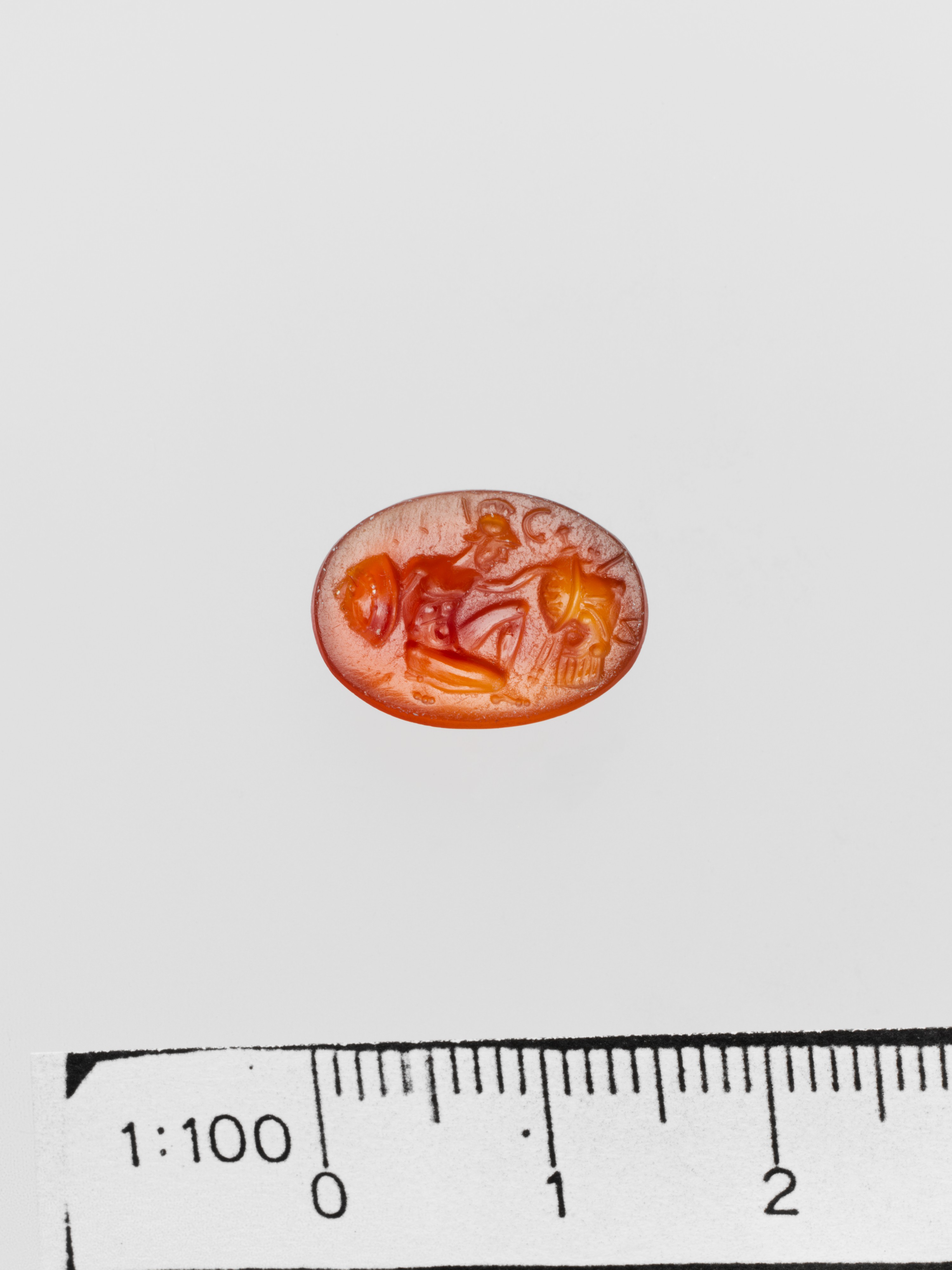 Carved Orange Gemstone with Measuring Ruler