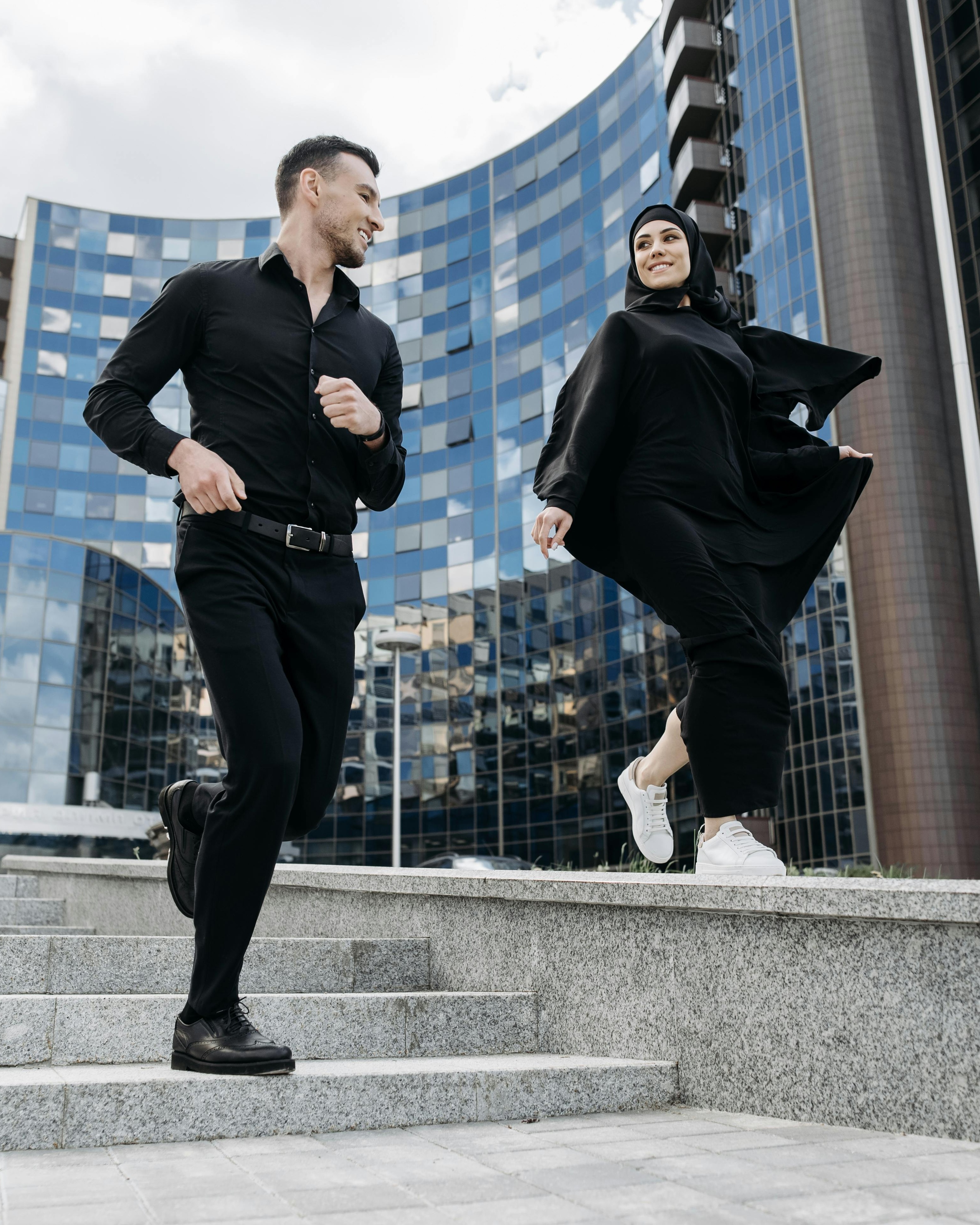 Couple Running Up Urban Stairs