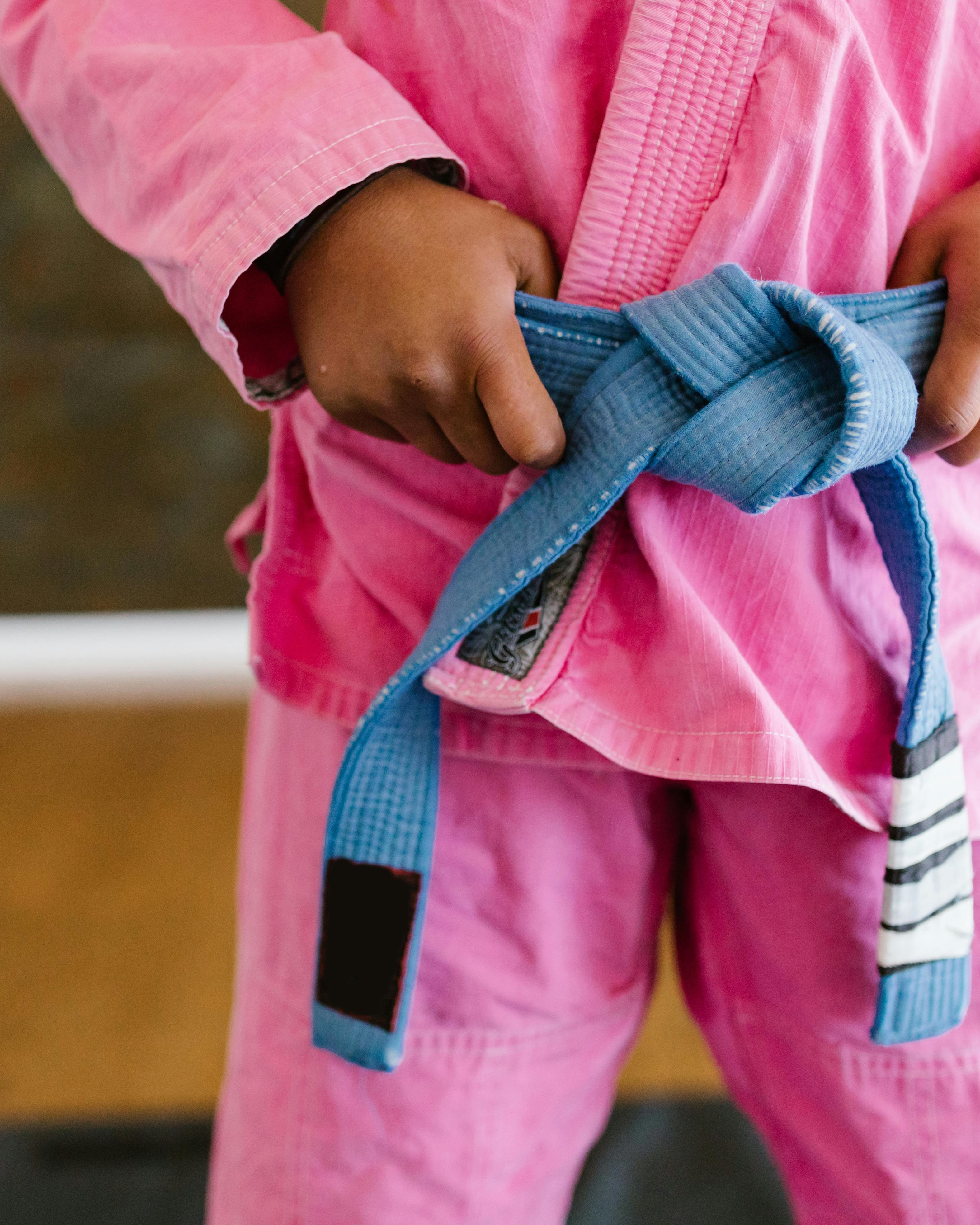 Child Tying Blue Martial Arts Belt