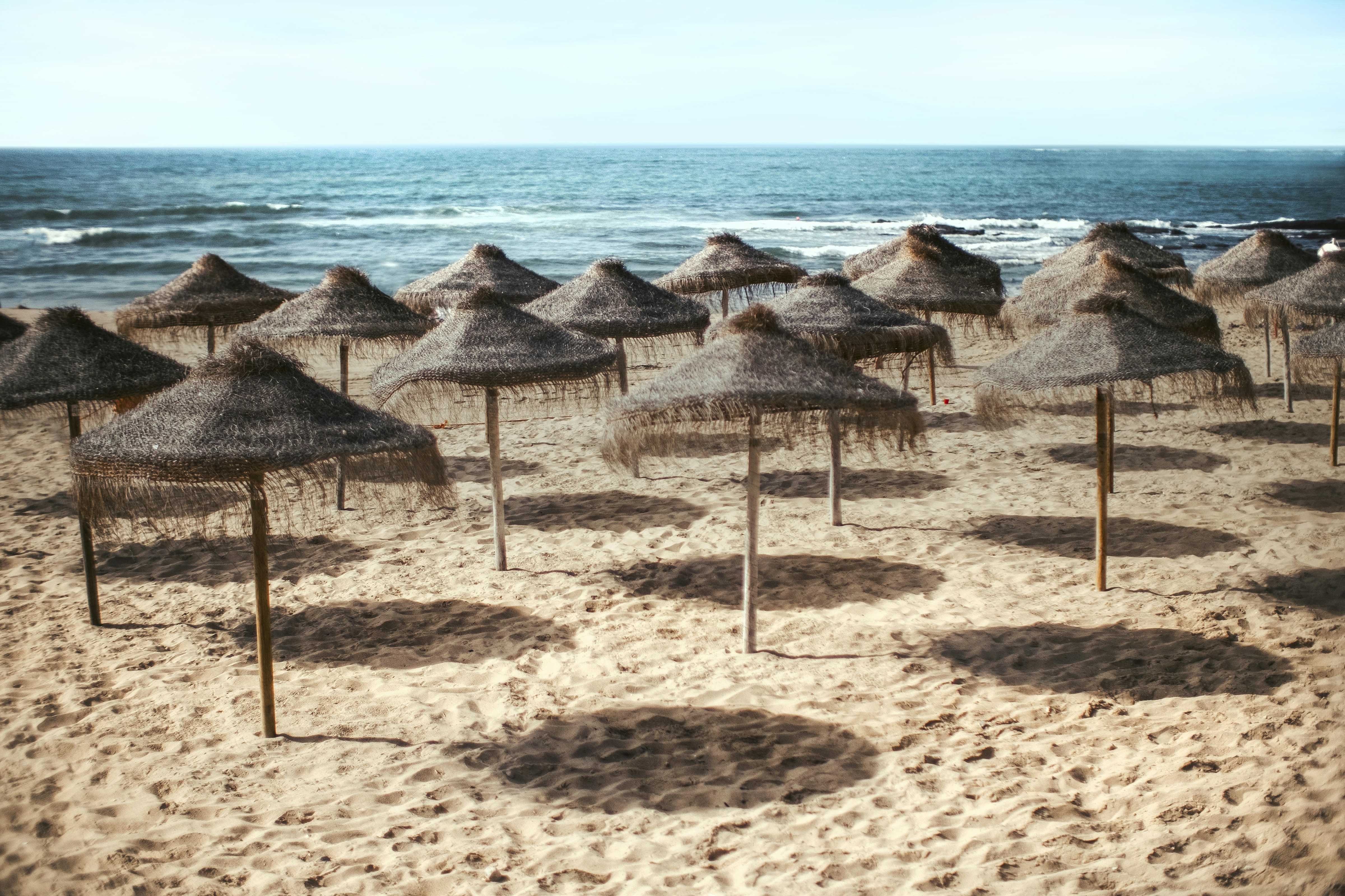 Beach Straw Umbrellas by the Sea