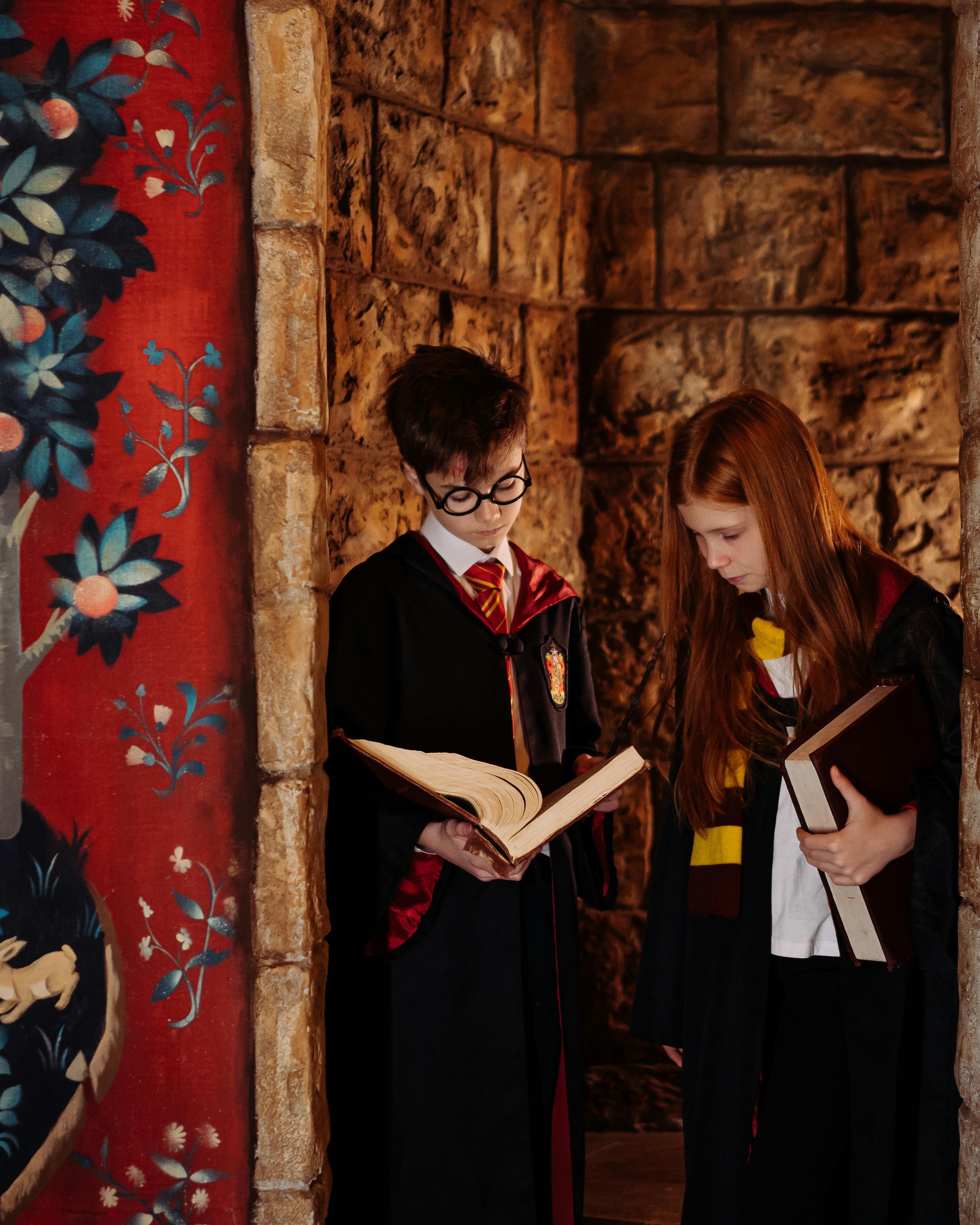 Two Kids in Hogwarts Costumes Reading