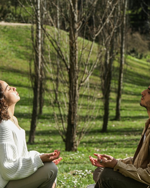 Two People Meditating Outdoors in a Park