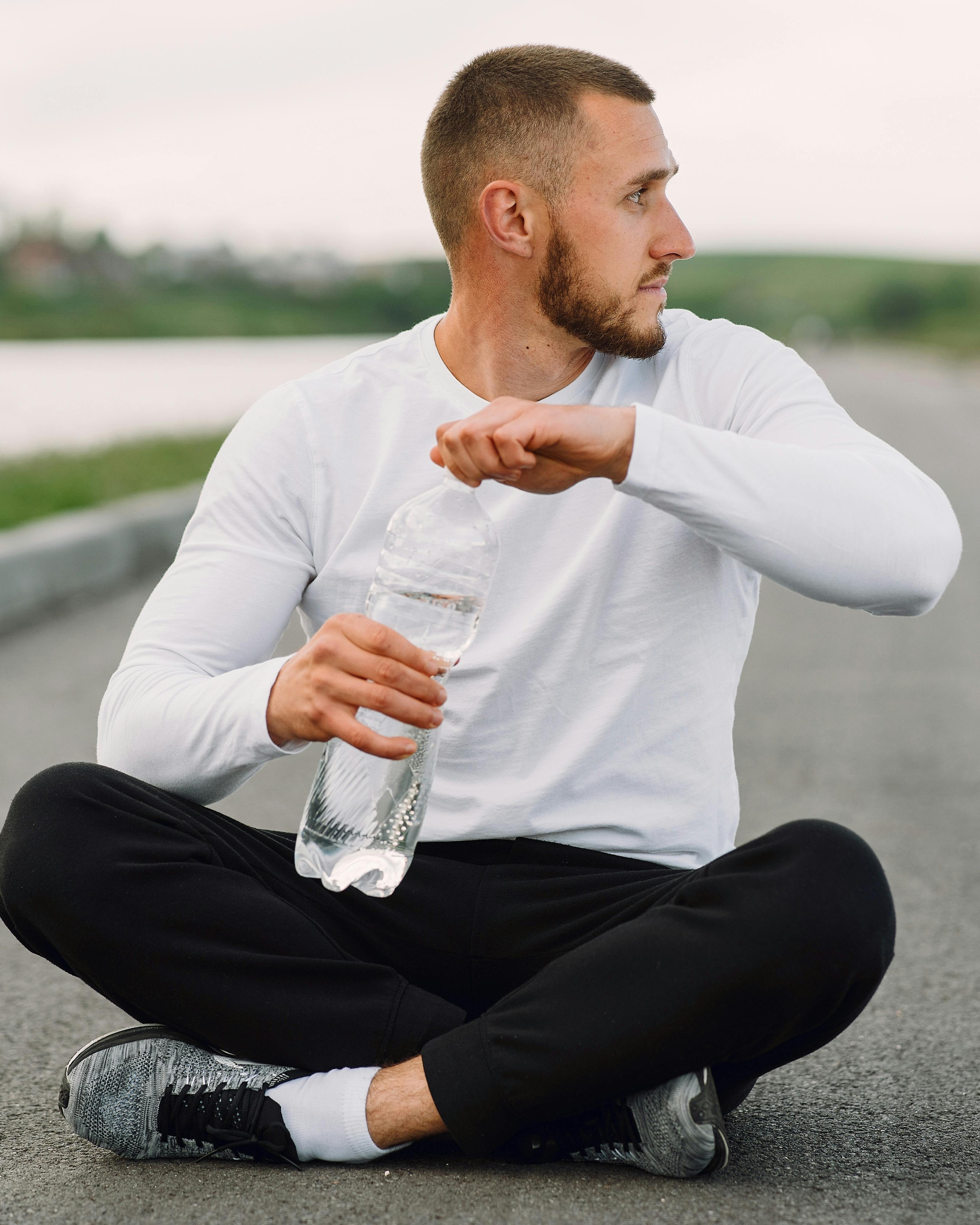 Man Resting After Workout Opening Water Bottle