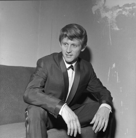 Young Man in Tuxedo Sitting on Sofa