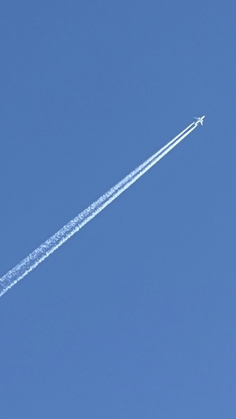 Airplane and Contrails on Clear Blue Sky