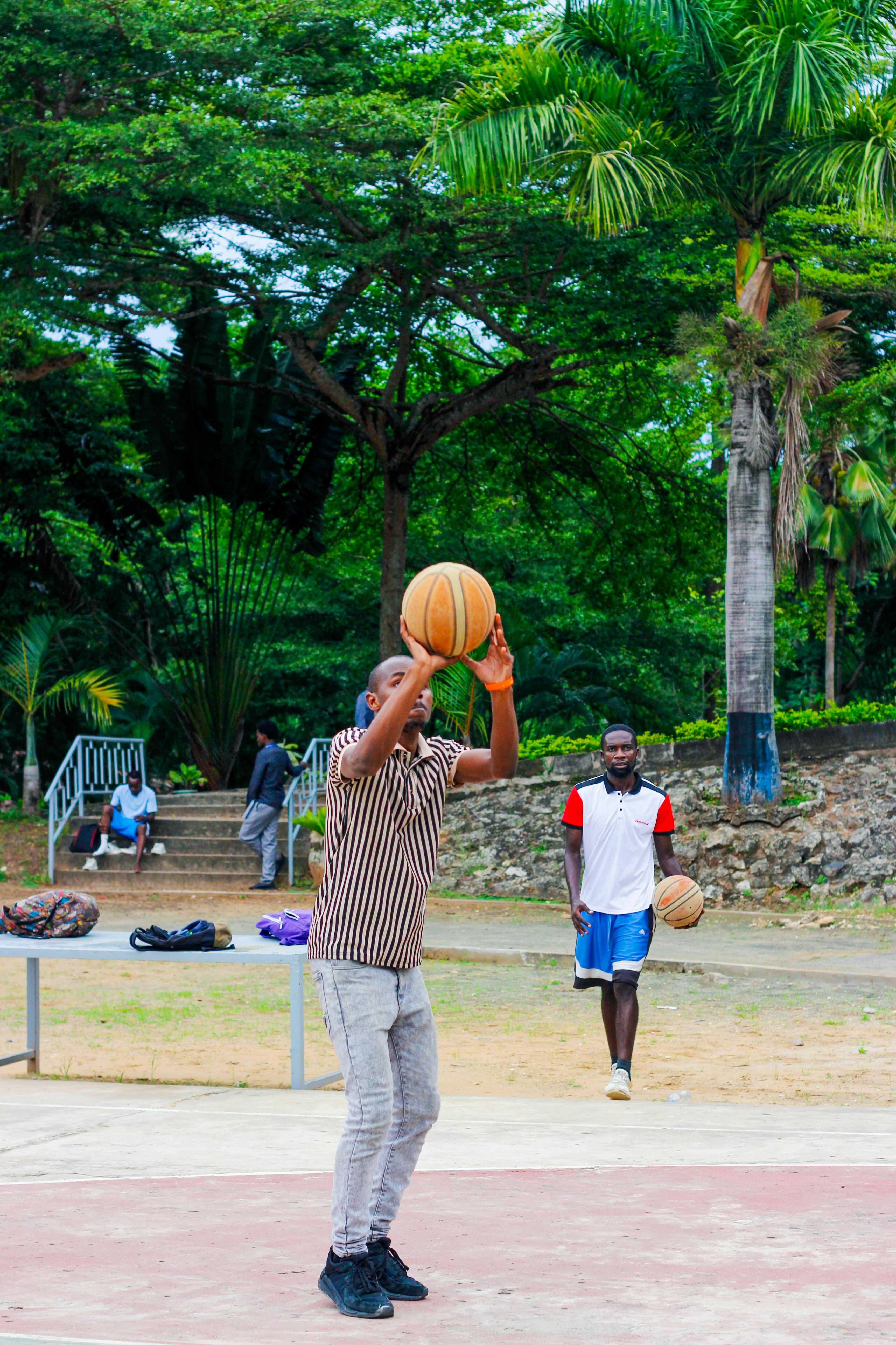 Men Playing Basketball Outdoors