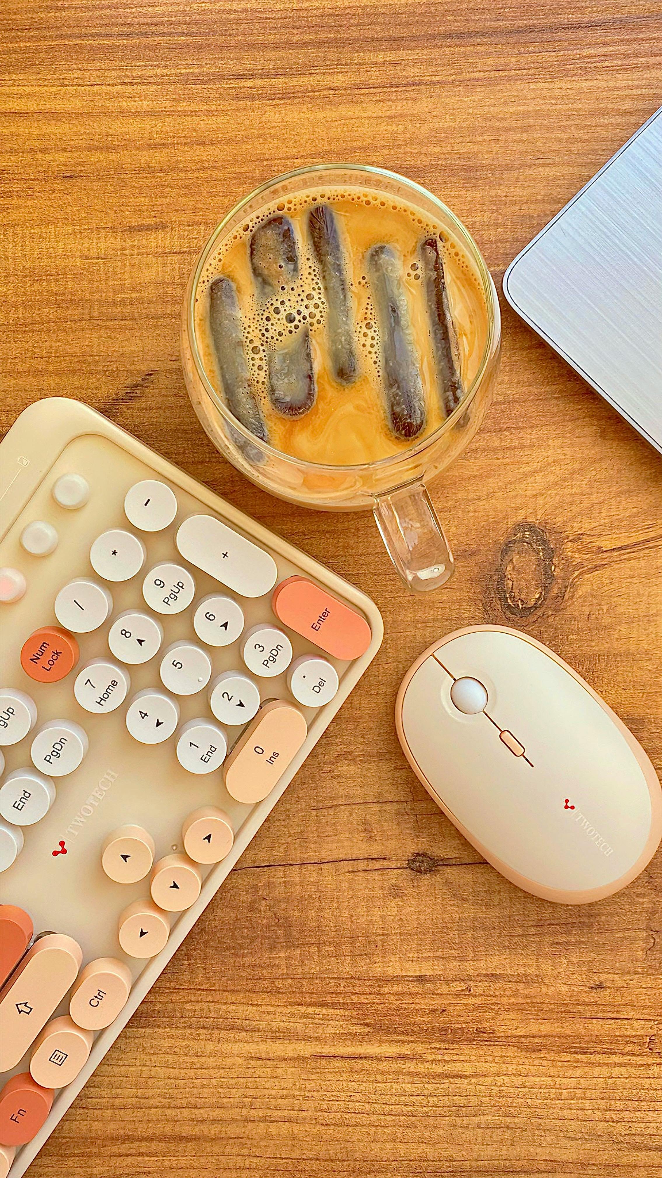 Iced Coffee and Tech Gear on Wooden Desk
