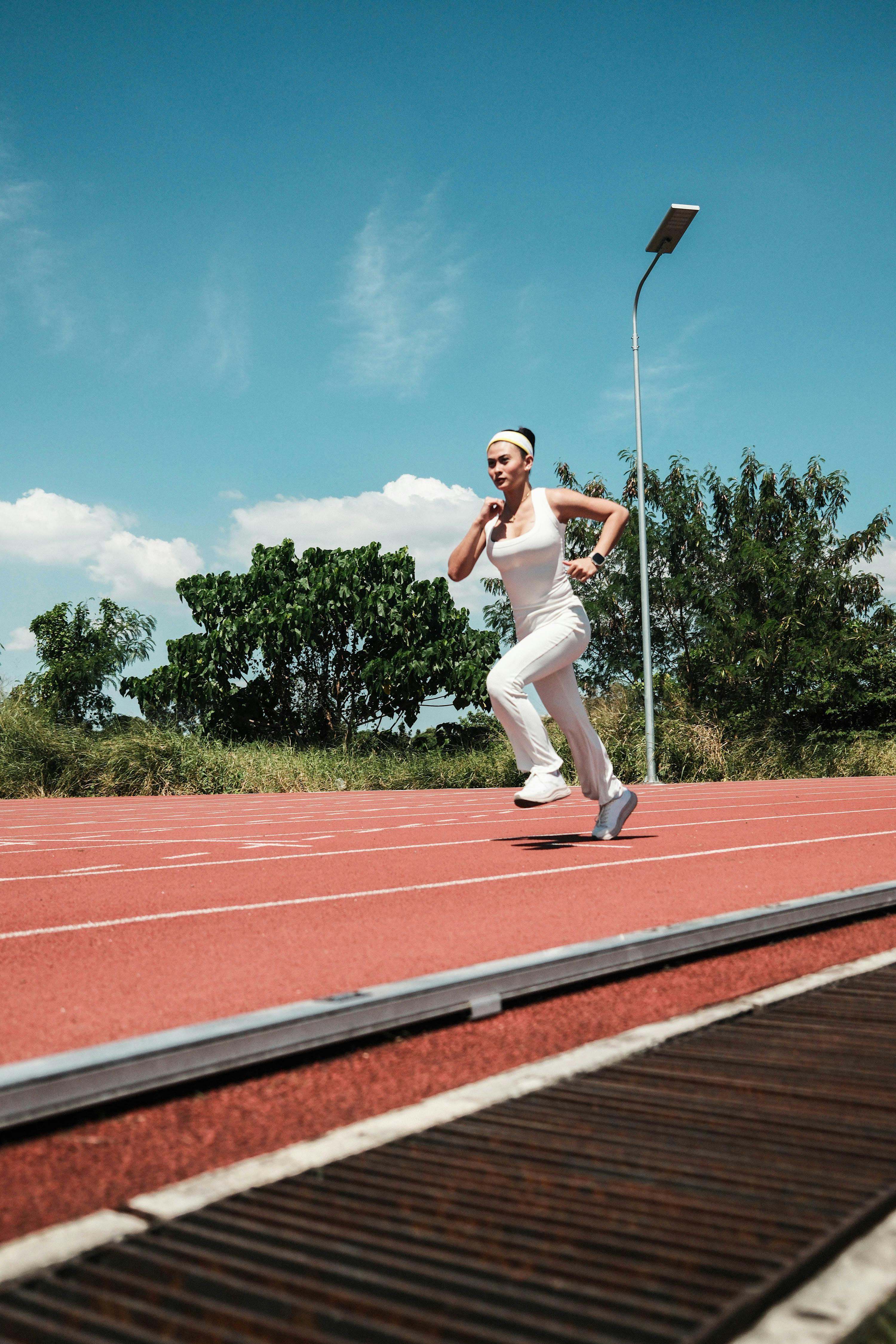 Woman Jogging on Outdoor Running Track