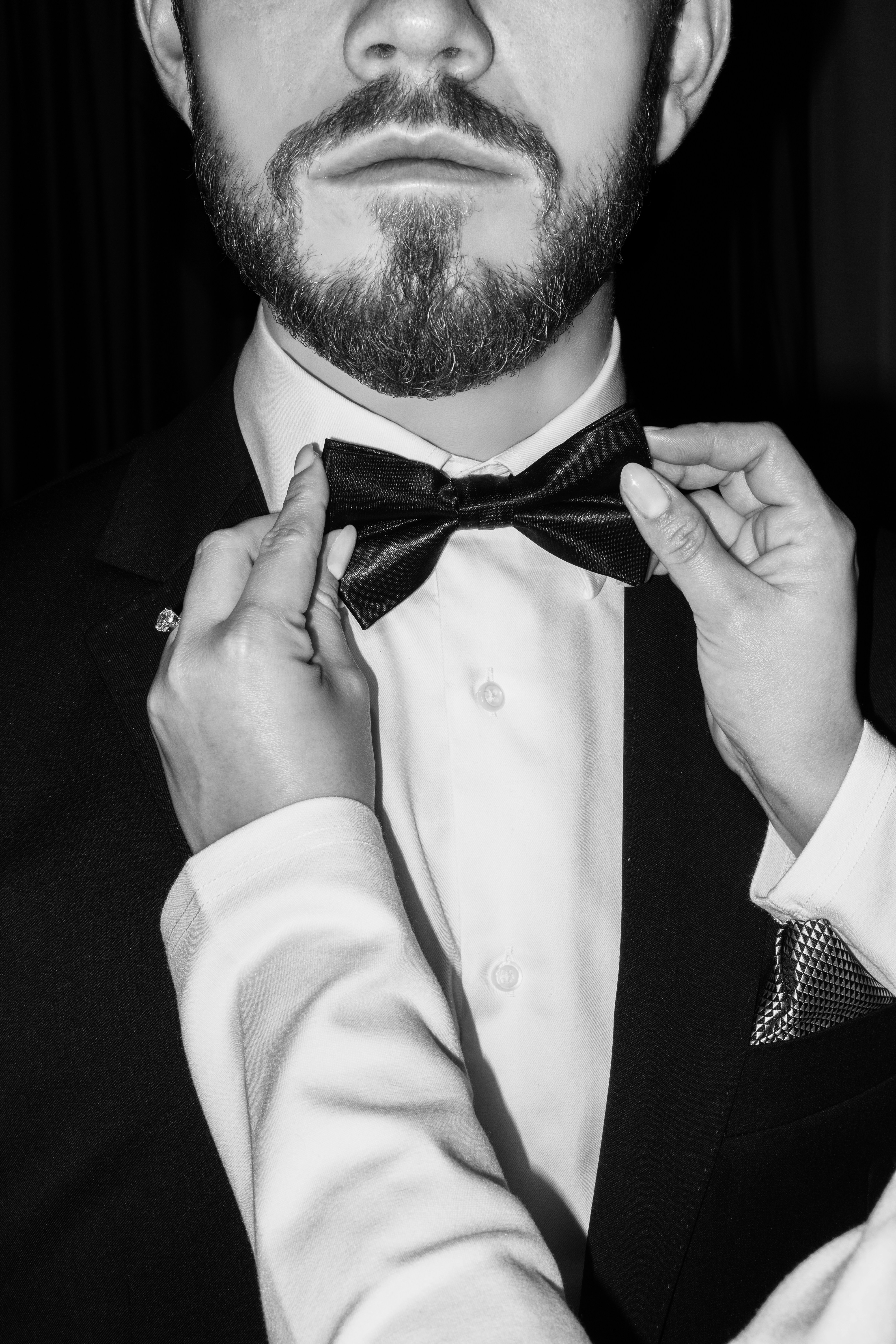 Woman Adjusting Man's Bow Tie